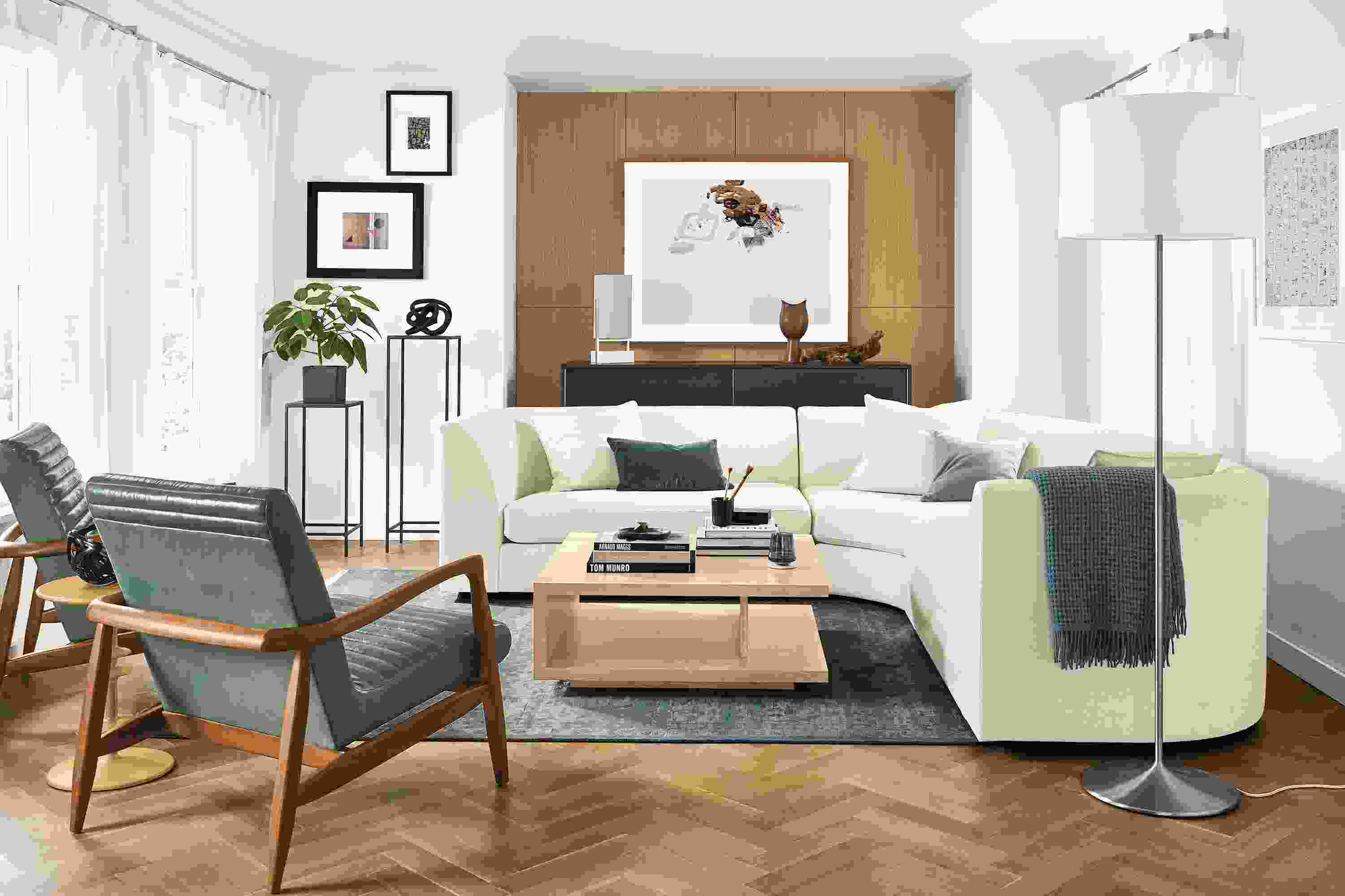 Living room with astaire 3-piece curved sectional in sumner ivory, 2 callan chairs in vento teal leather and graham table in salt.