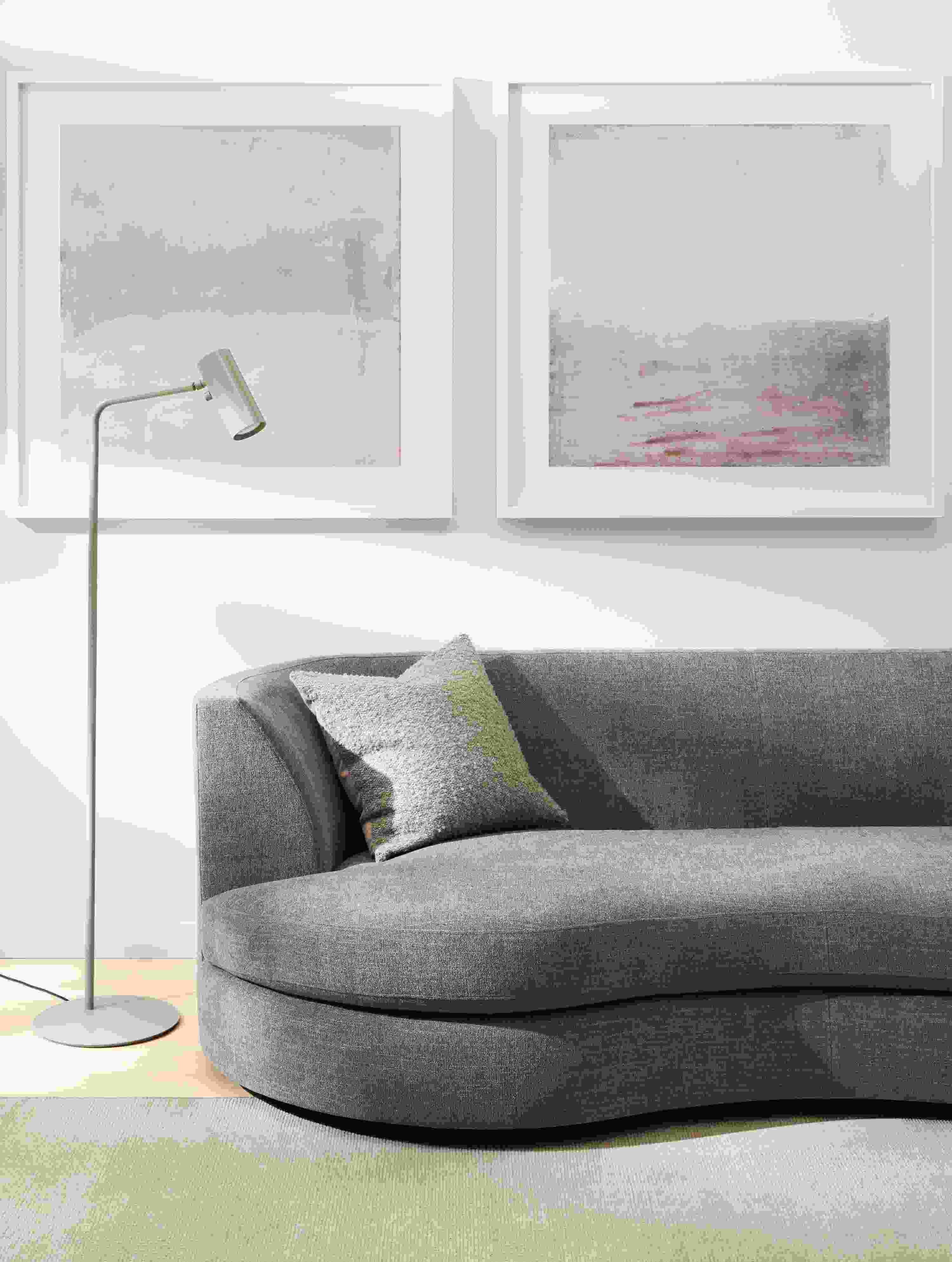 Detail of Astaire curved sofa with Samar rug, Chantal Talbot artwork and Chronicle floor lamp.