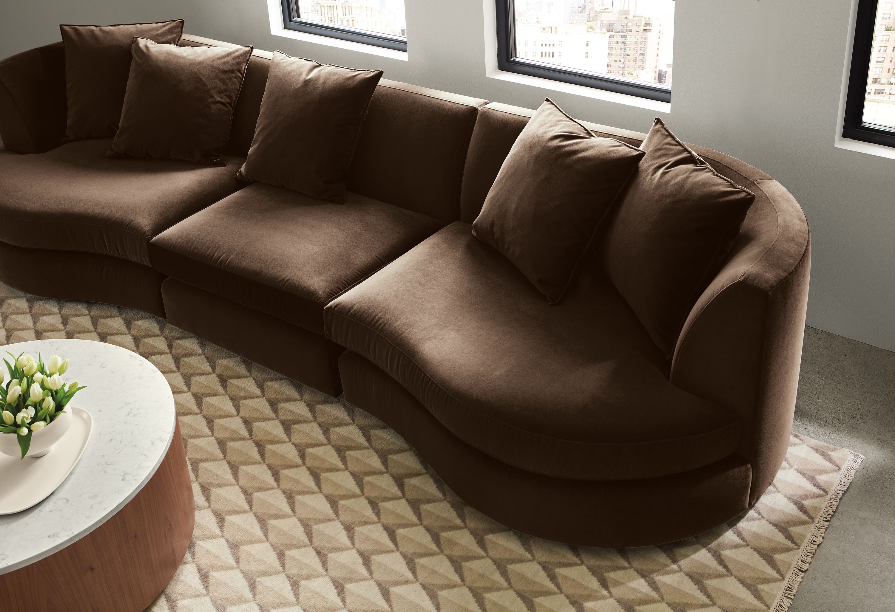 Detail view from above of Astaire three-piece sofa in Redding Espresso and Plaza 8 by 10 rug in ivory/taupe.