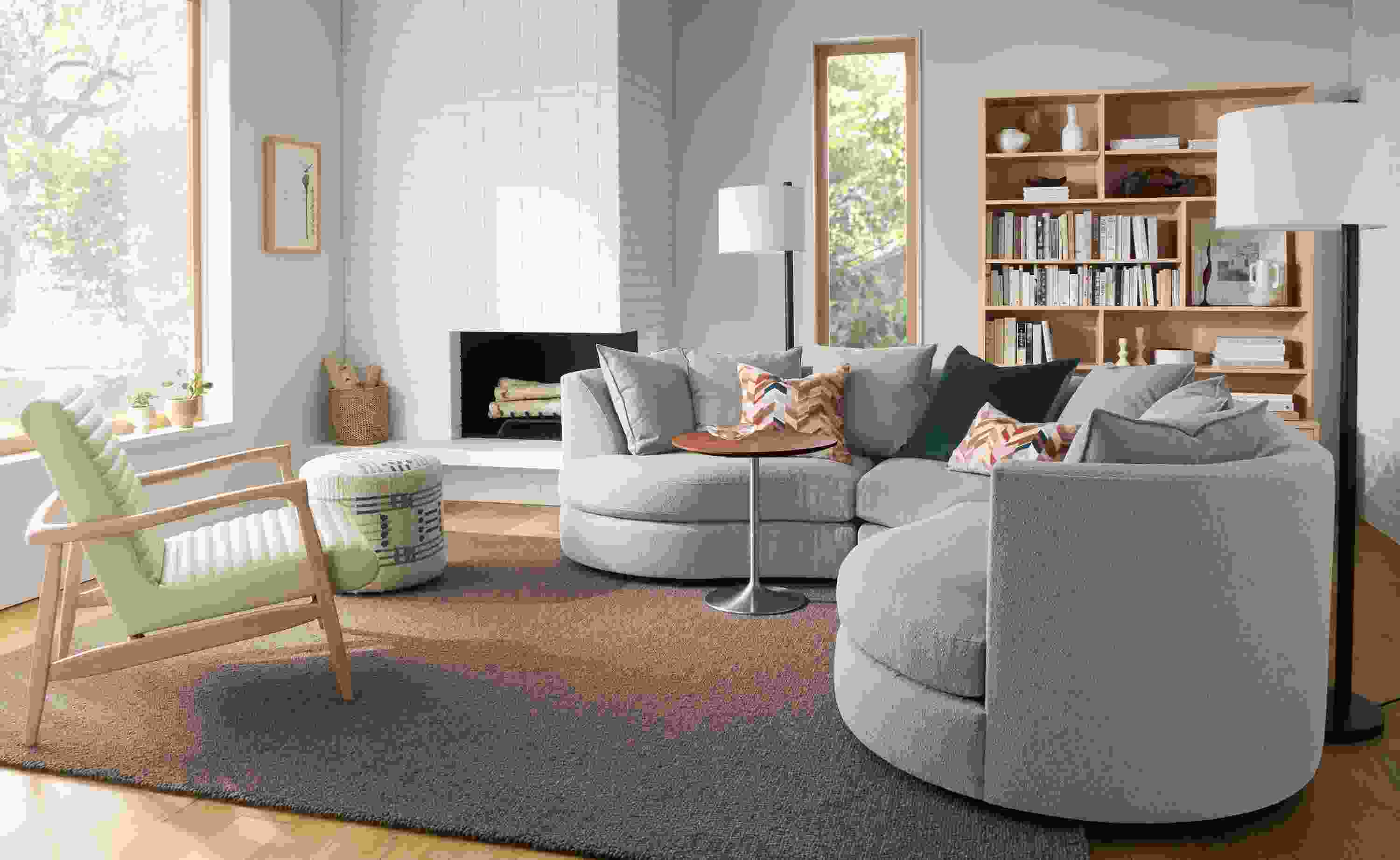 Living room with Astaire 100 by 100 sectional in Declan Cement and Arden low-loop 8 by 10 rug in Earth.
