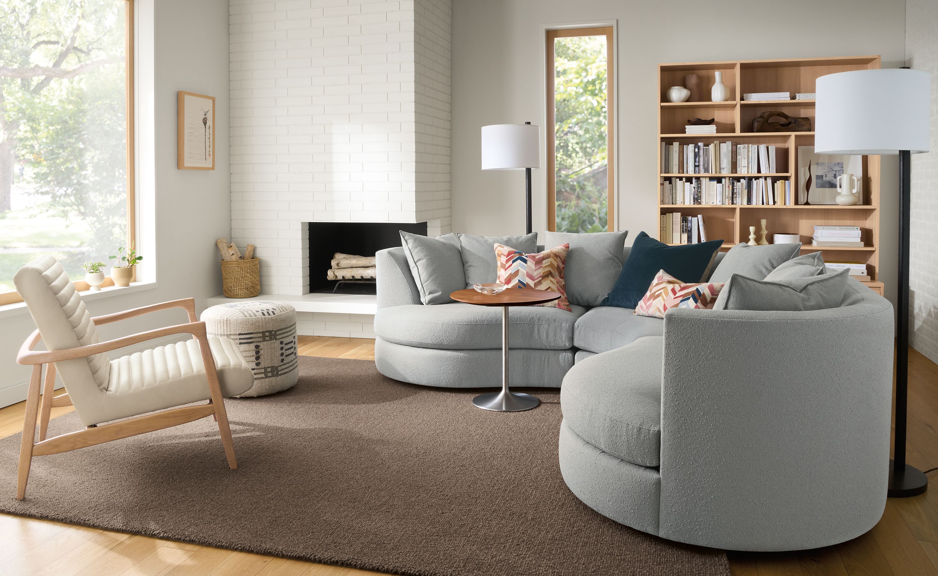 Living room with Astaire 100 by 100 sectional in Declan Cement and Arden low-loop 8 by 10 rug in Earth.