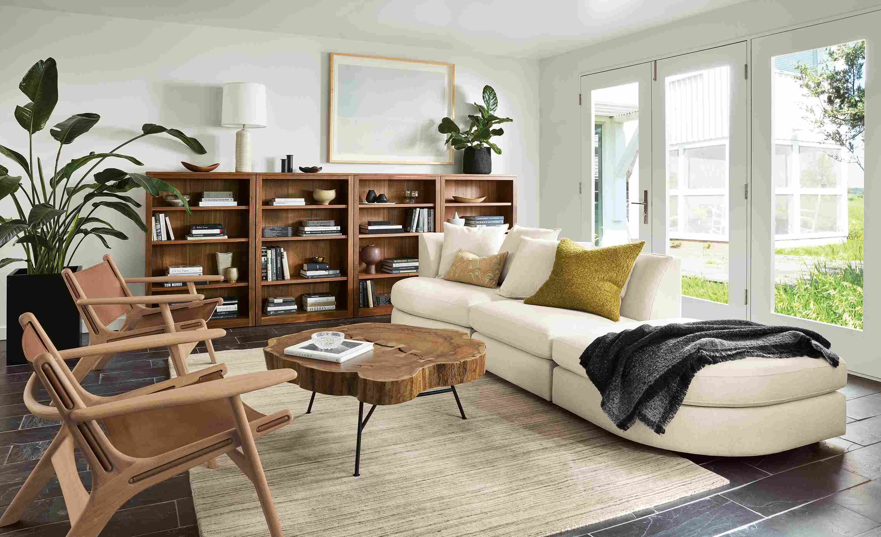 Living room with Astaire sofa and chair and ottoman in sumner ivory and 2 Lars lounge chairs in Sellare Cognac.
