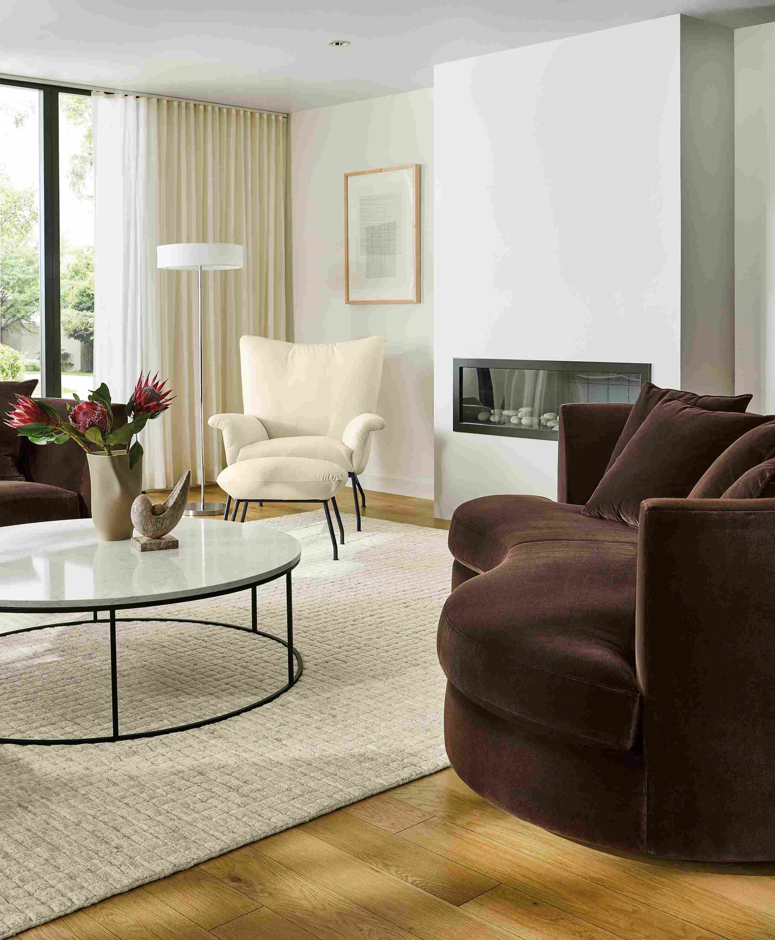Living room with Astaire 94-wide bench cushio curved sofa in Redding Espresso fabric and Safira rug in grey.