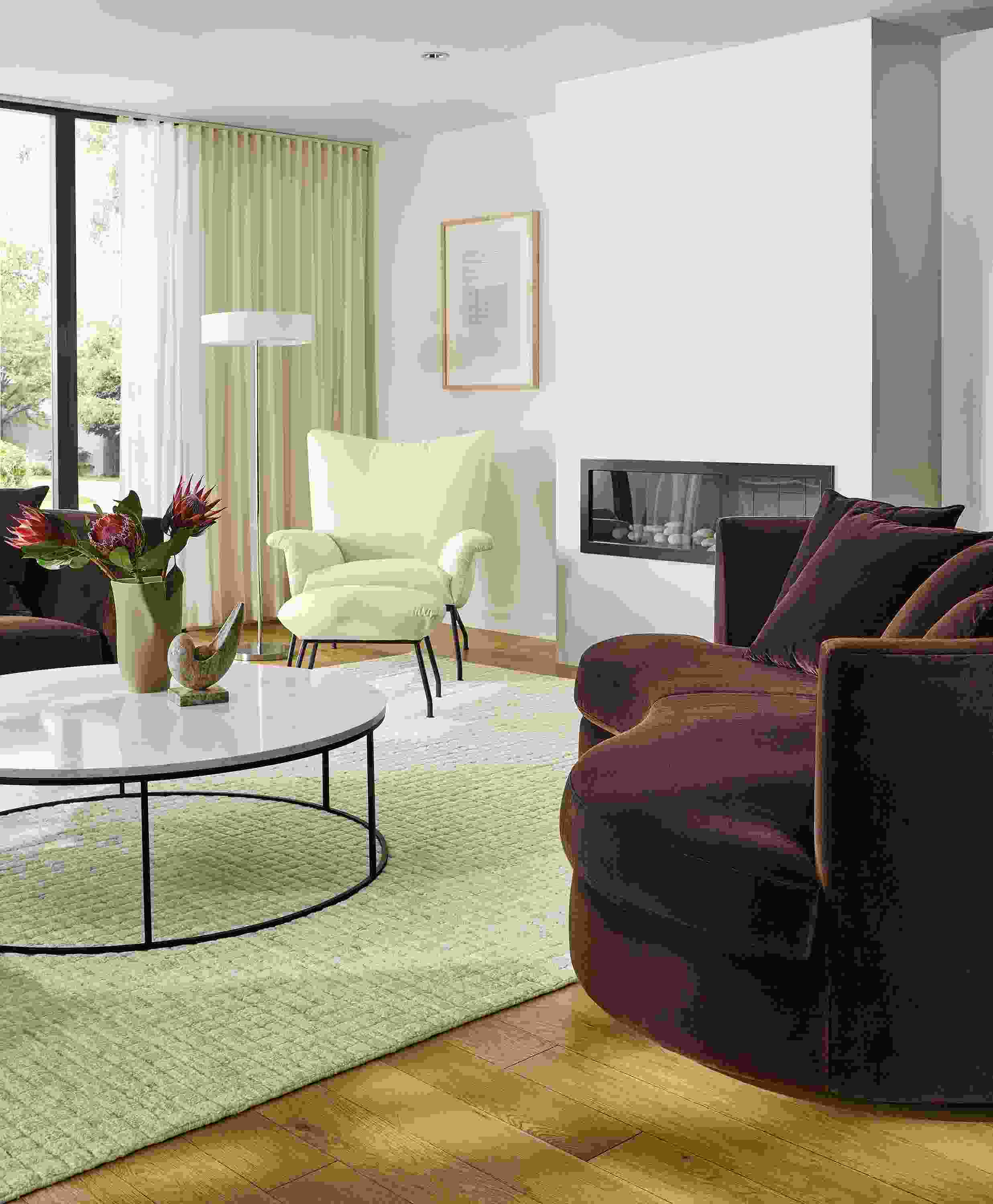 Living room with Astaire 94-wide bench cushio curved sofa in Redding Espresso fabric and Safira rug in grey.
