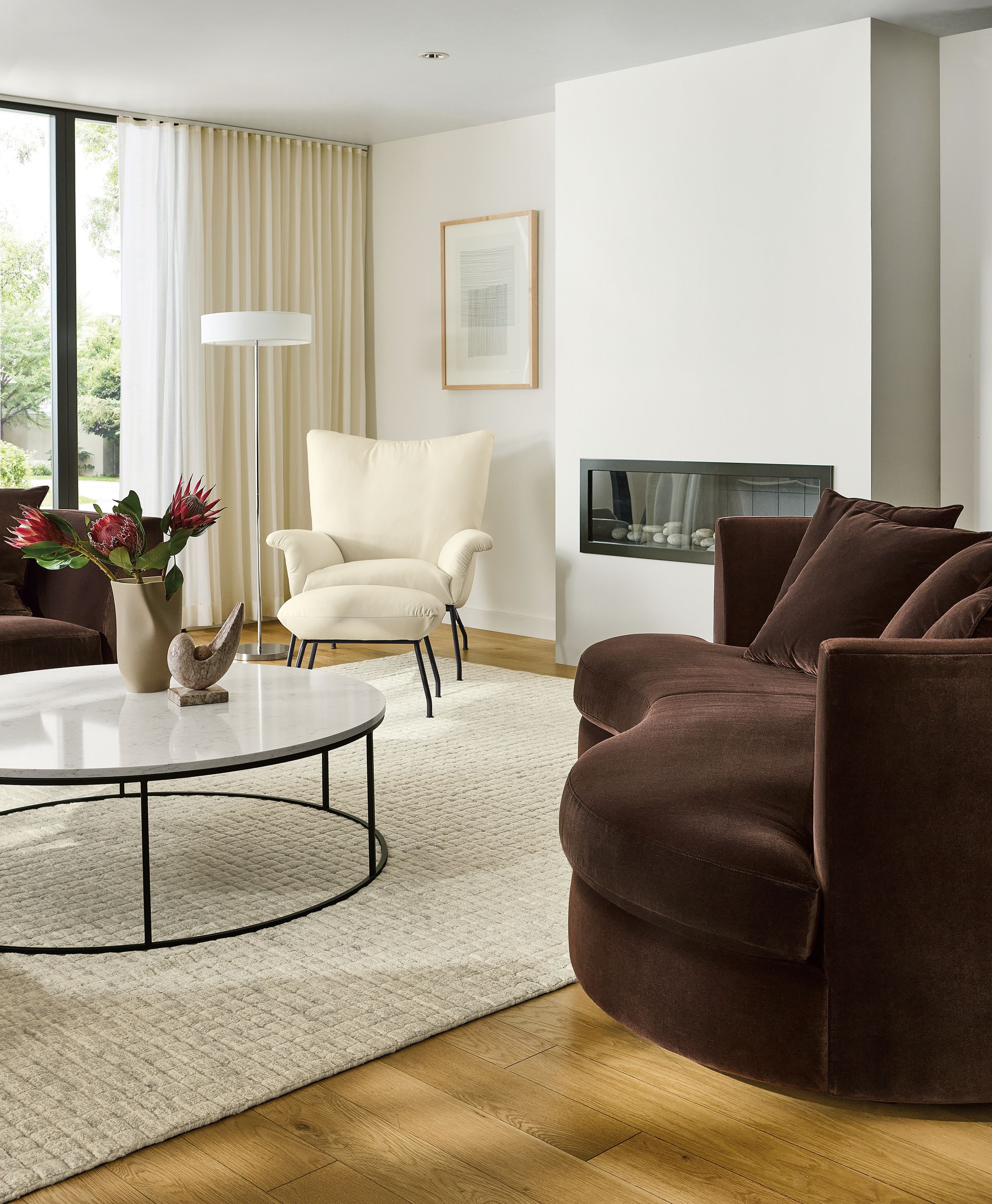 Living room with Astaire 94-wide bench cushio curved sofa in Redding Espresso fabric and Safira rug in grey.