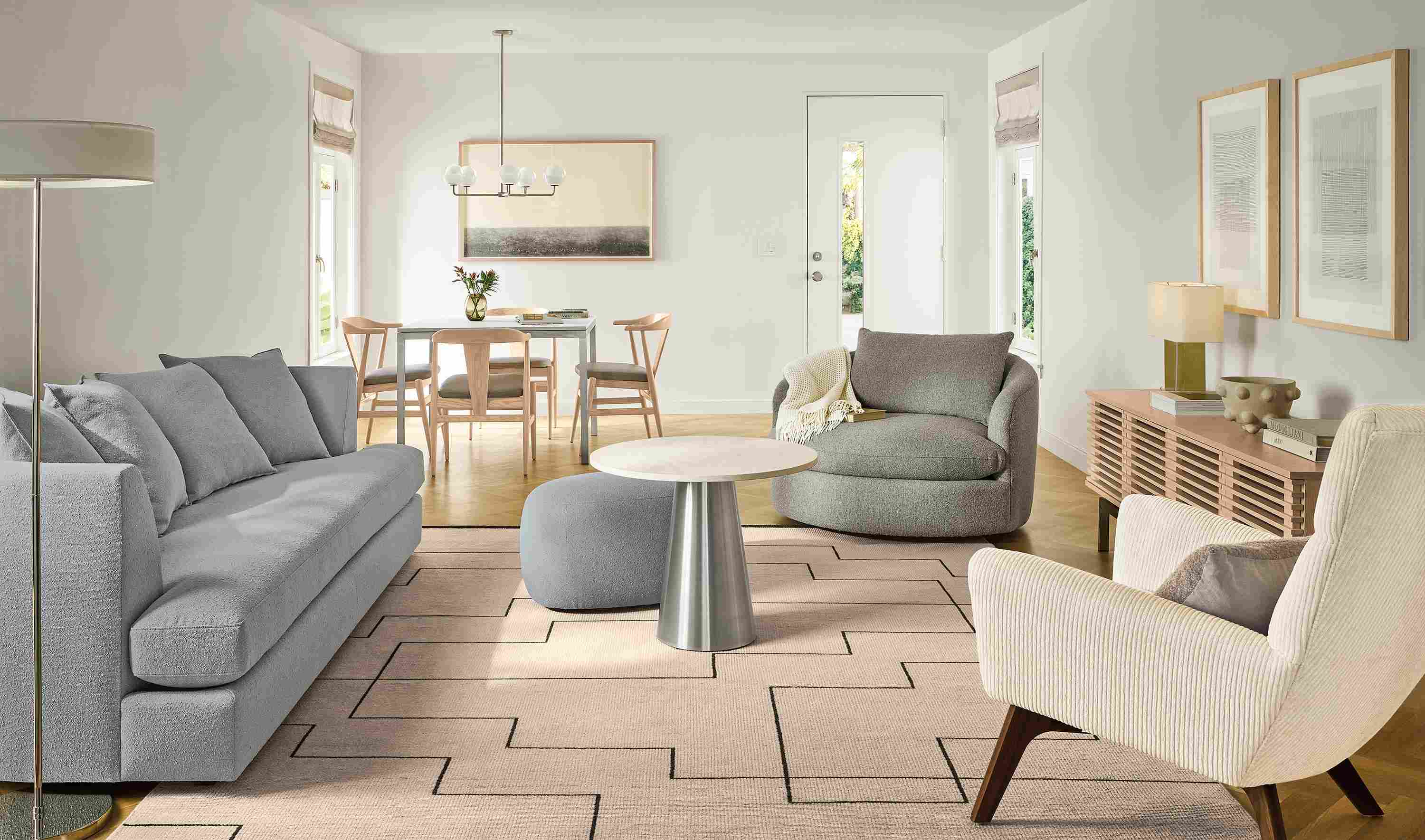 Living room with Astaire 90-wide sofa in Declan Cement, Suri swivel chair in Conley Grey and Navi rug in ivory/black.