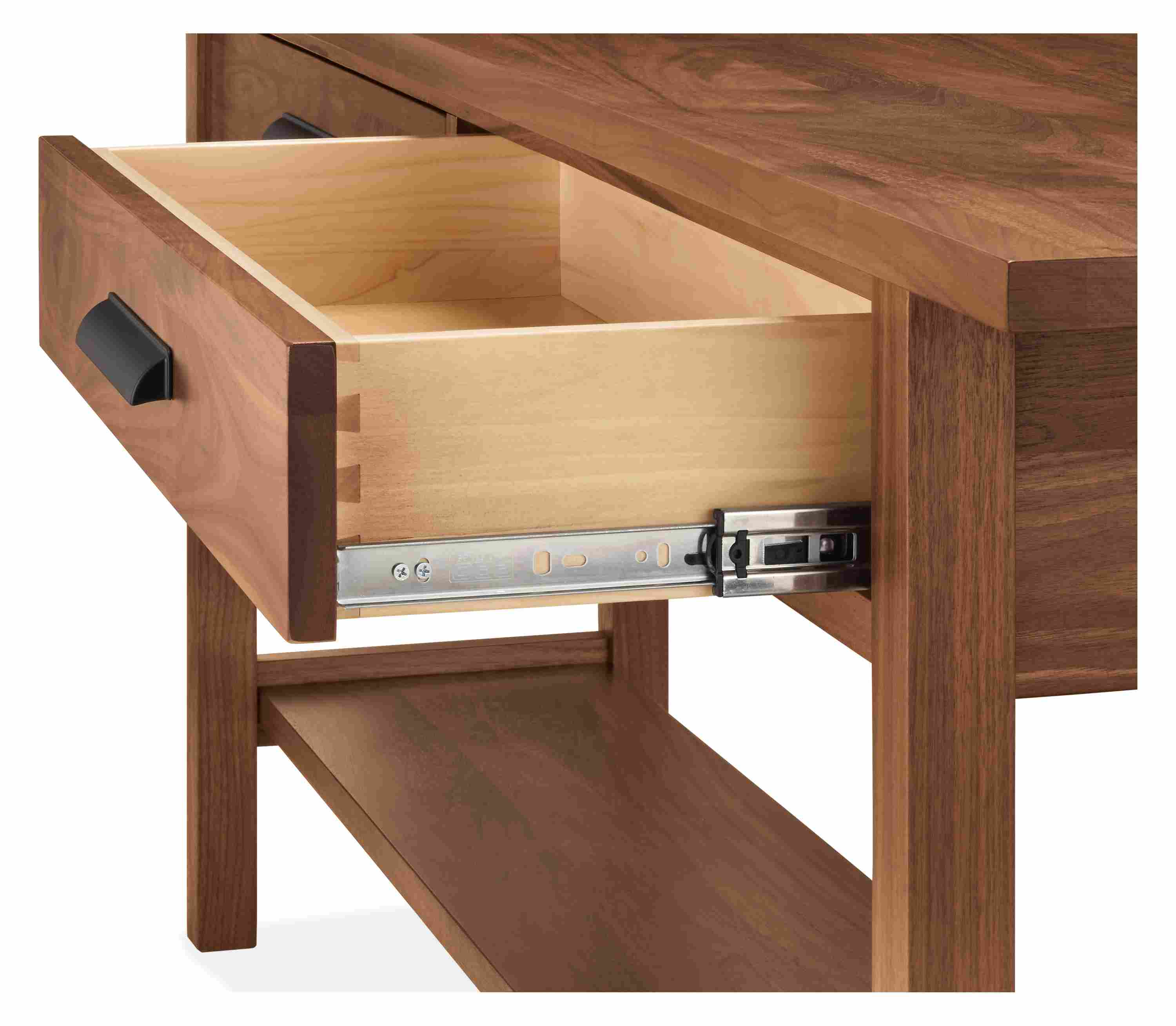 Detail of open drawer and slide mechanism on an Atherton 78-wide console table in walnut with graphite pulls.