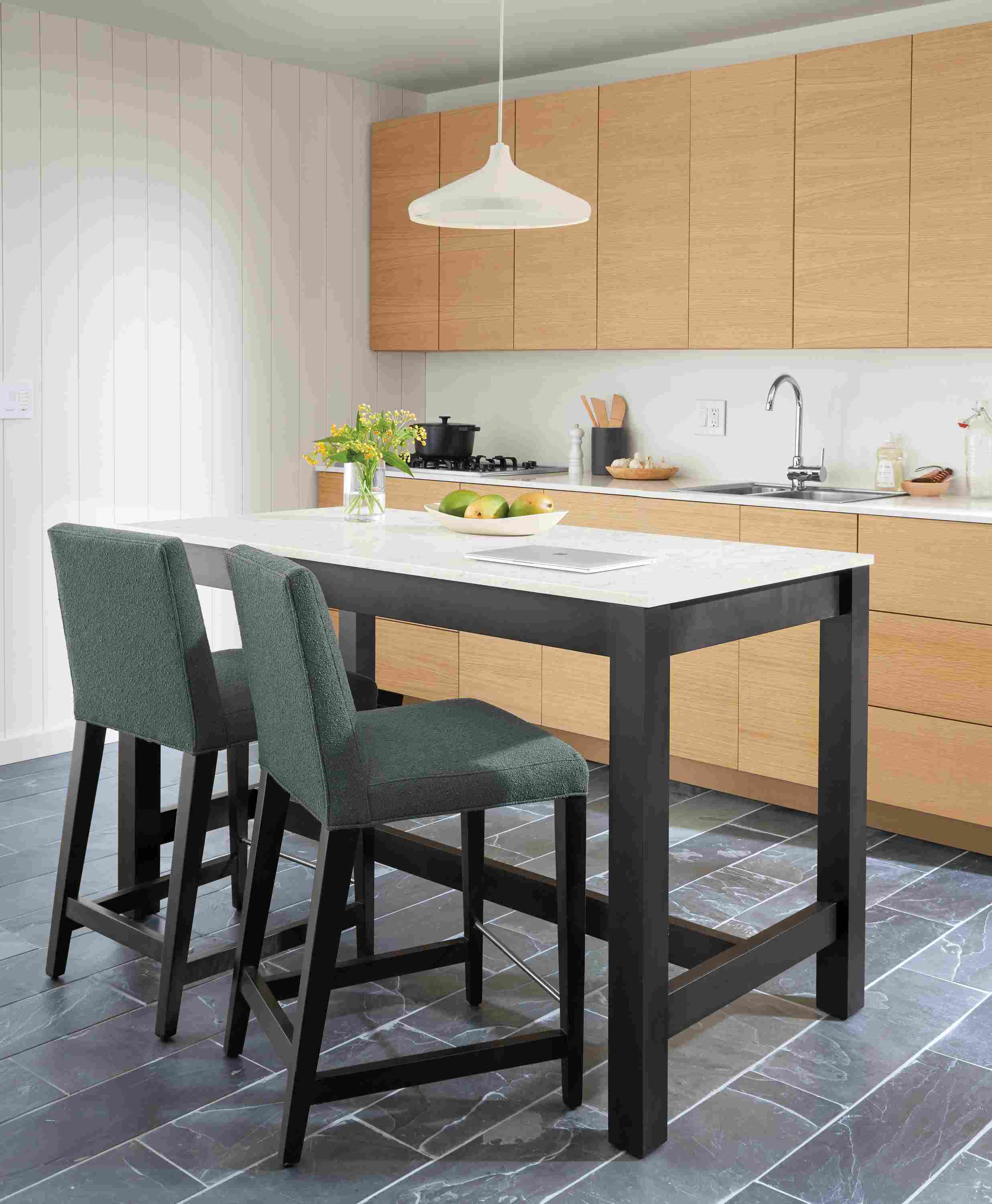 Detail of 2 Ava counter stools in Declan Haze fabric at Linden counter table.