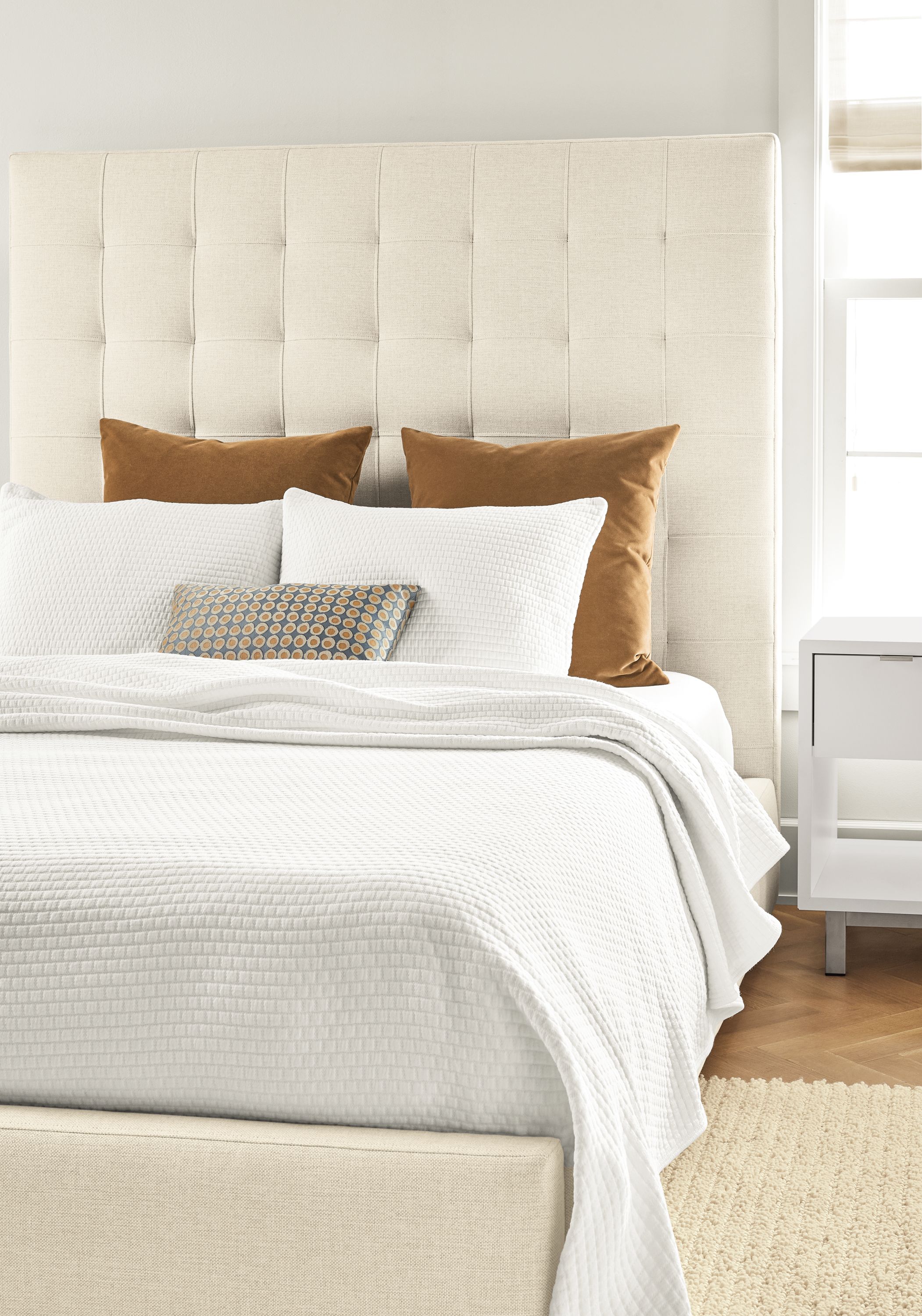 Detail of Avery queen storage bed in Sumner Ivory fabric.