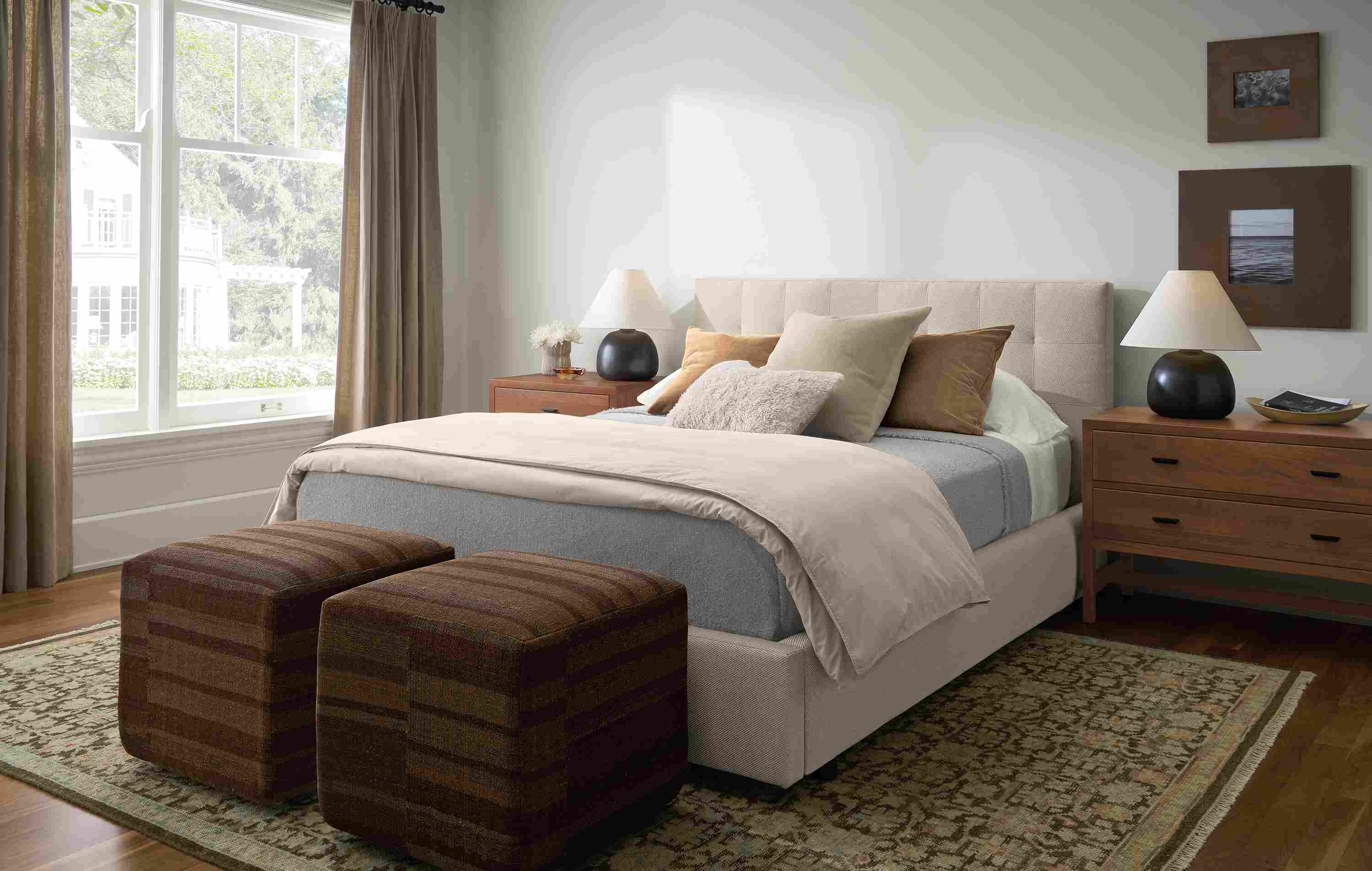 Bedroom with Avery queen bed in Derry Flax,  2 Indira ottomans in Serra Umber and Rosalie rug in petal.