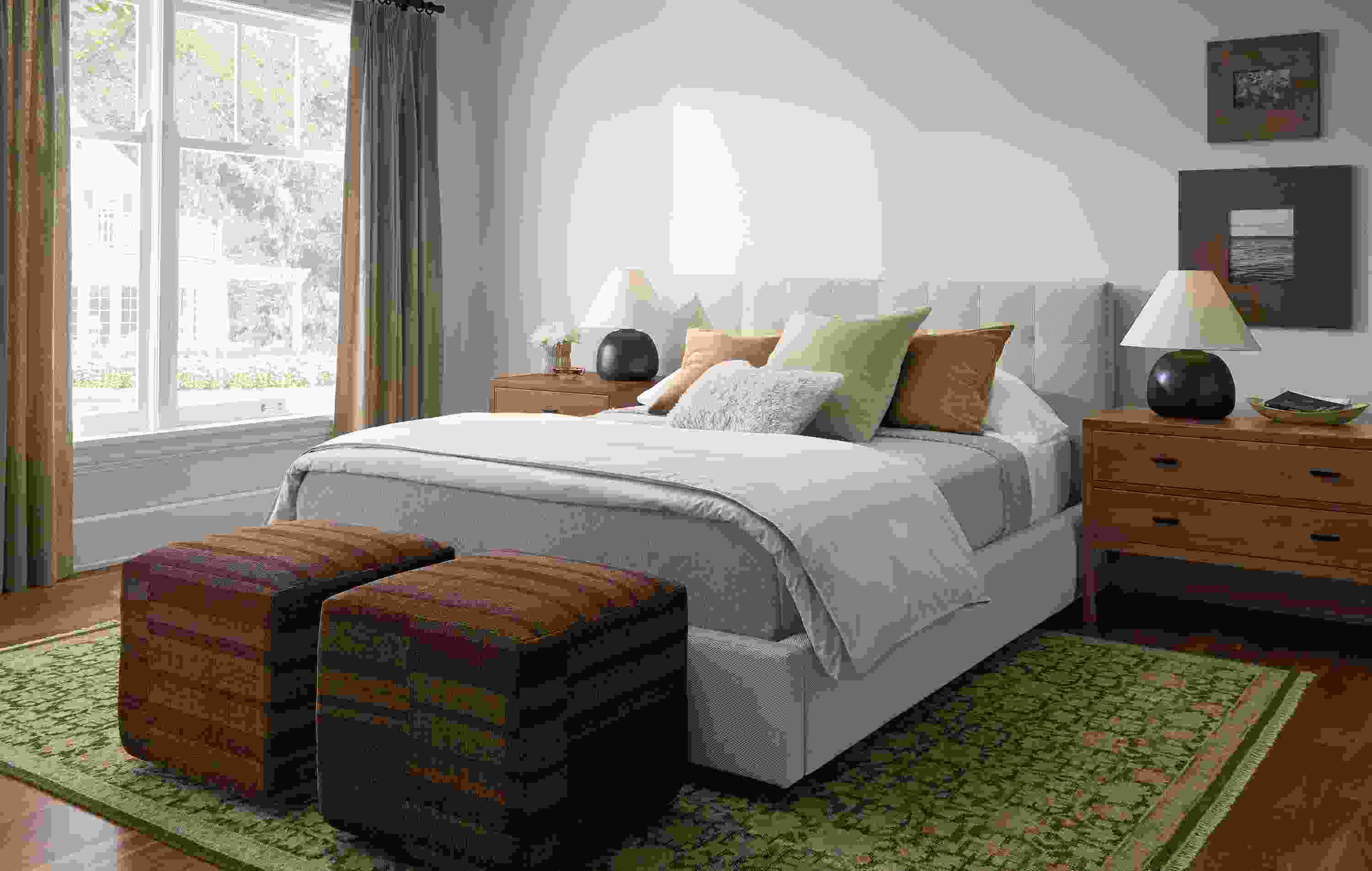Bedroom with Avery queen bed in Derry Flax,  2 Indira ottomans in Serra Umber and Rosalie rug in petal.