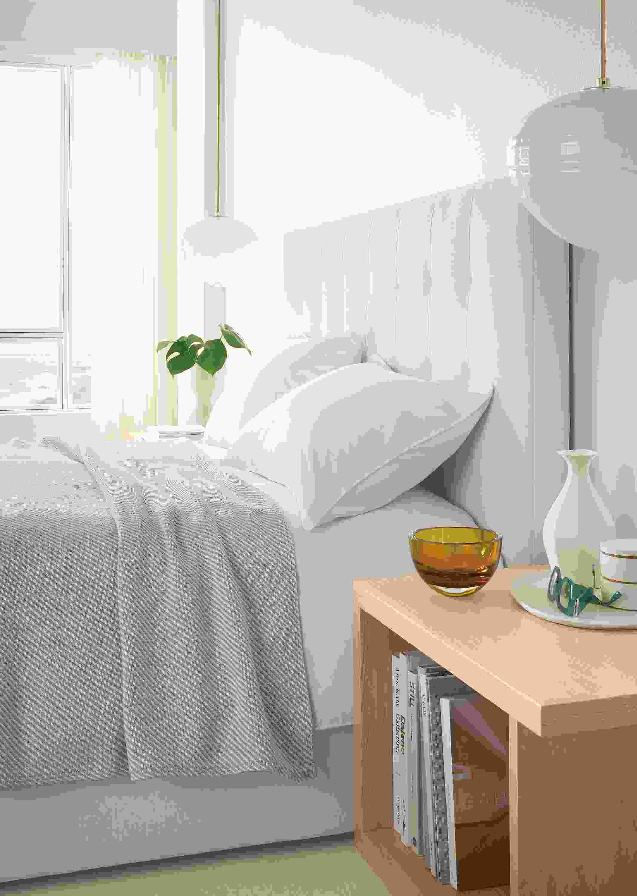 Bedroom with detail of Avery queen storage bed in Mori Ivory and Graham end table in salt on red oak.