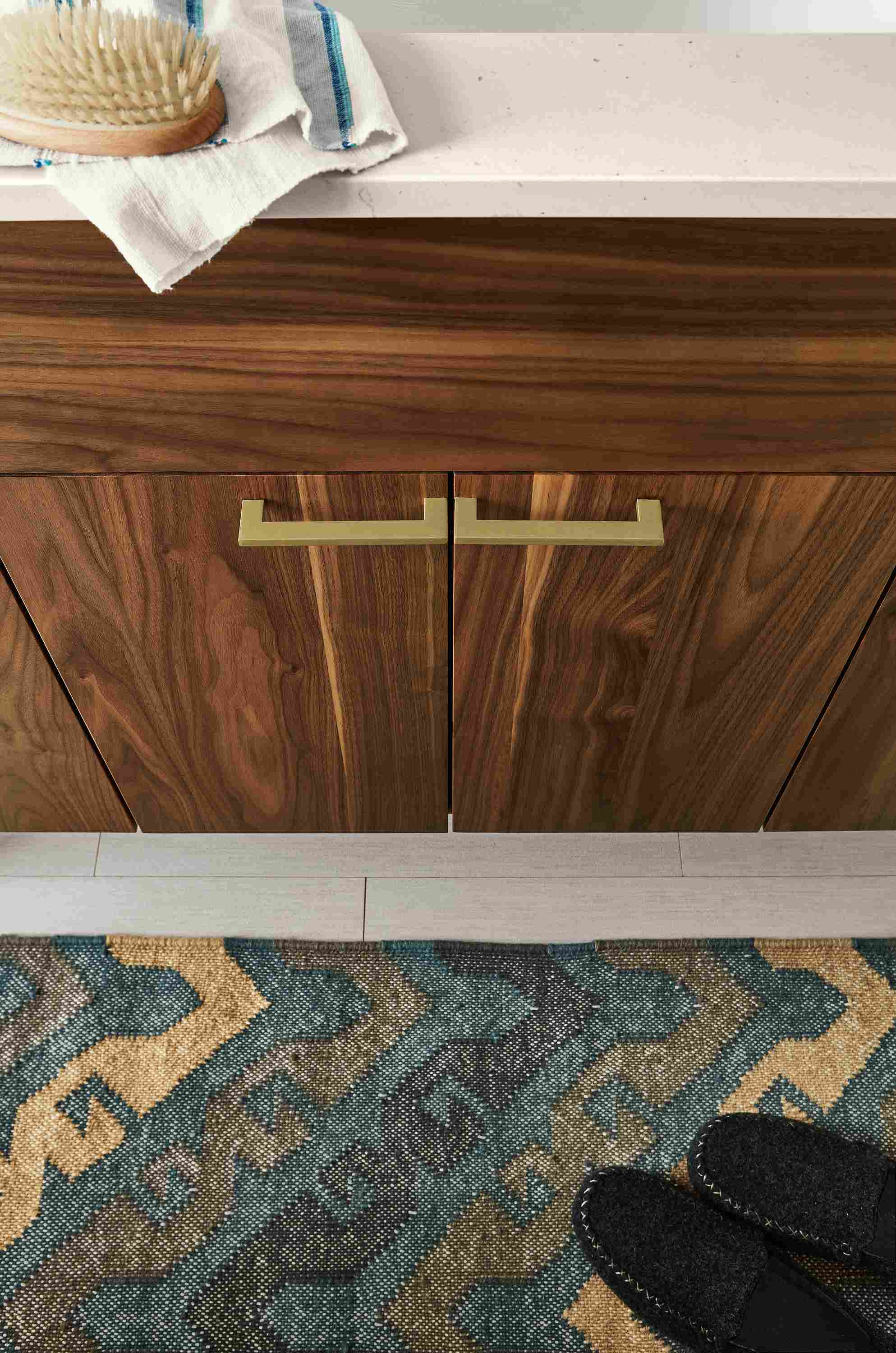 High-angle view of 2 Axton pulls in brushed gold powdercoat on a bathroom vanity.