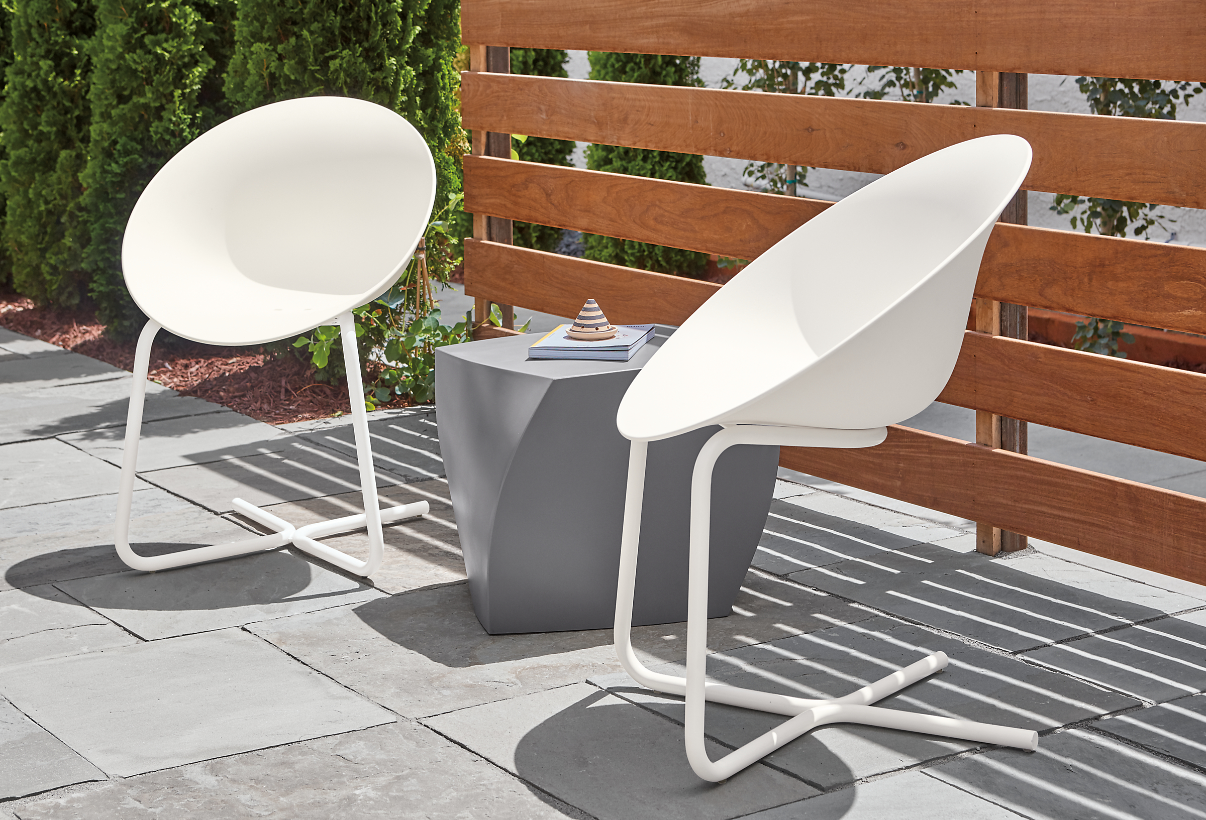 Side detail of Azhar outdoor white chairs.