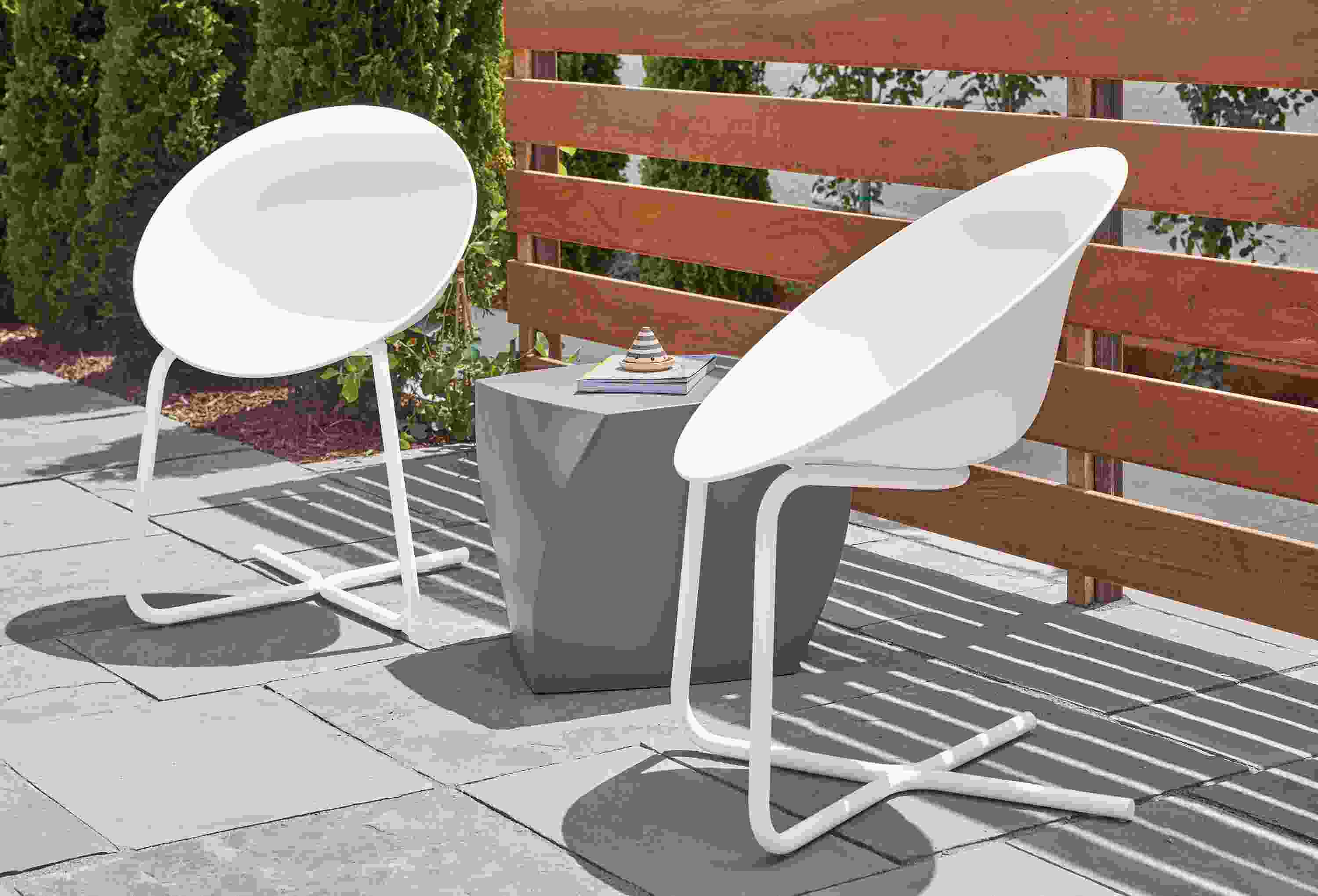 Side detail of Azhar outdoor white chairs.