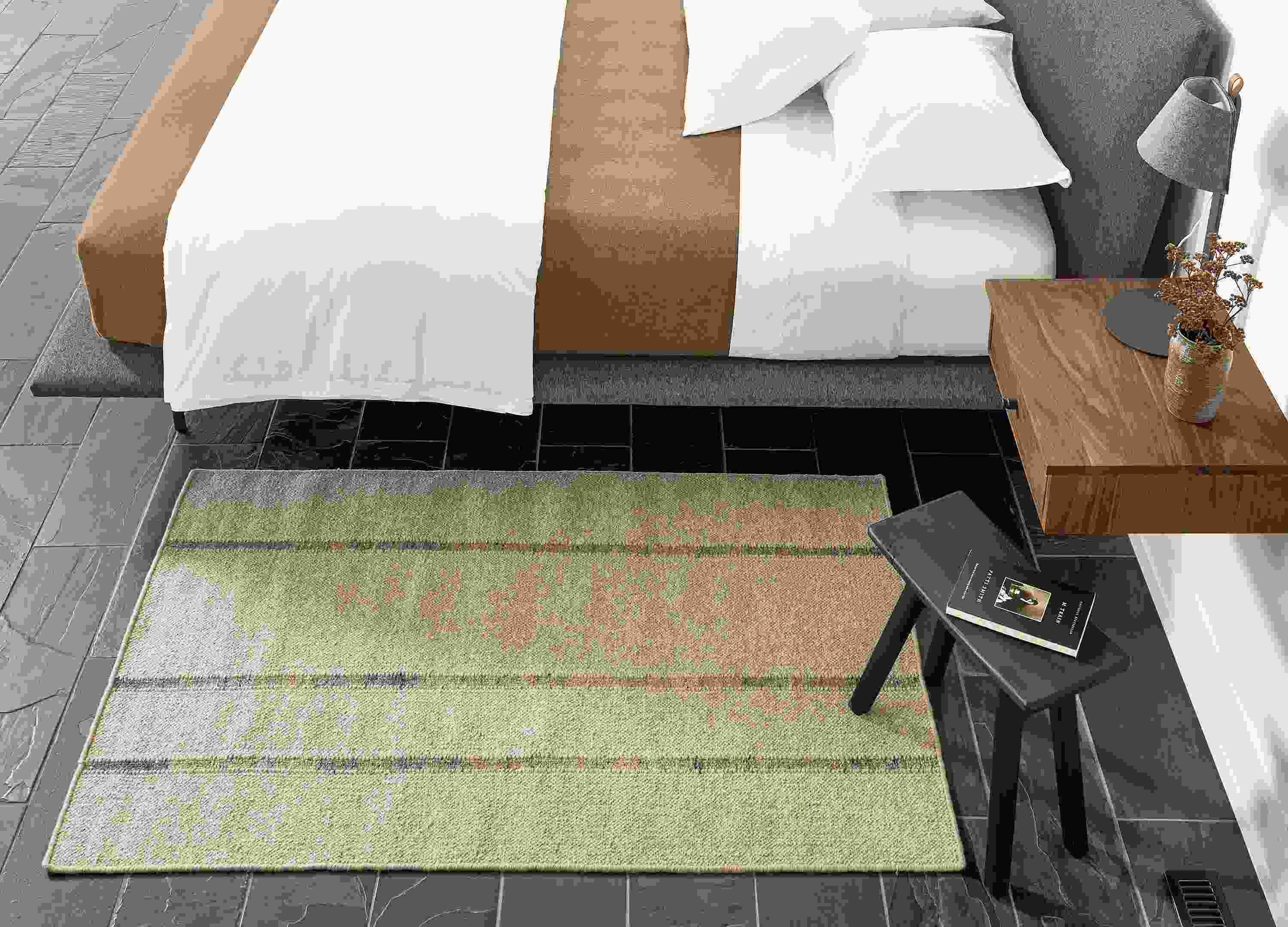 Detail of Bambu rug in Taupe in bedroom beside bed.