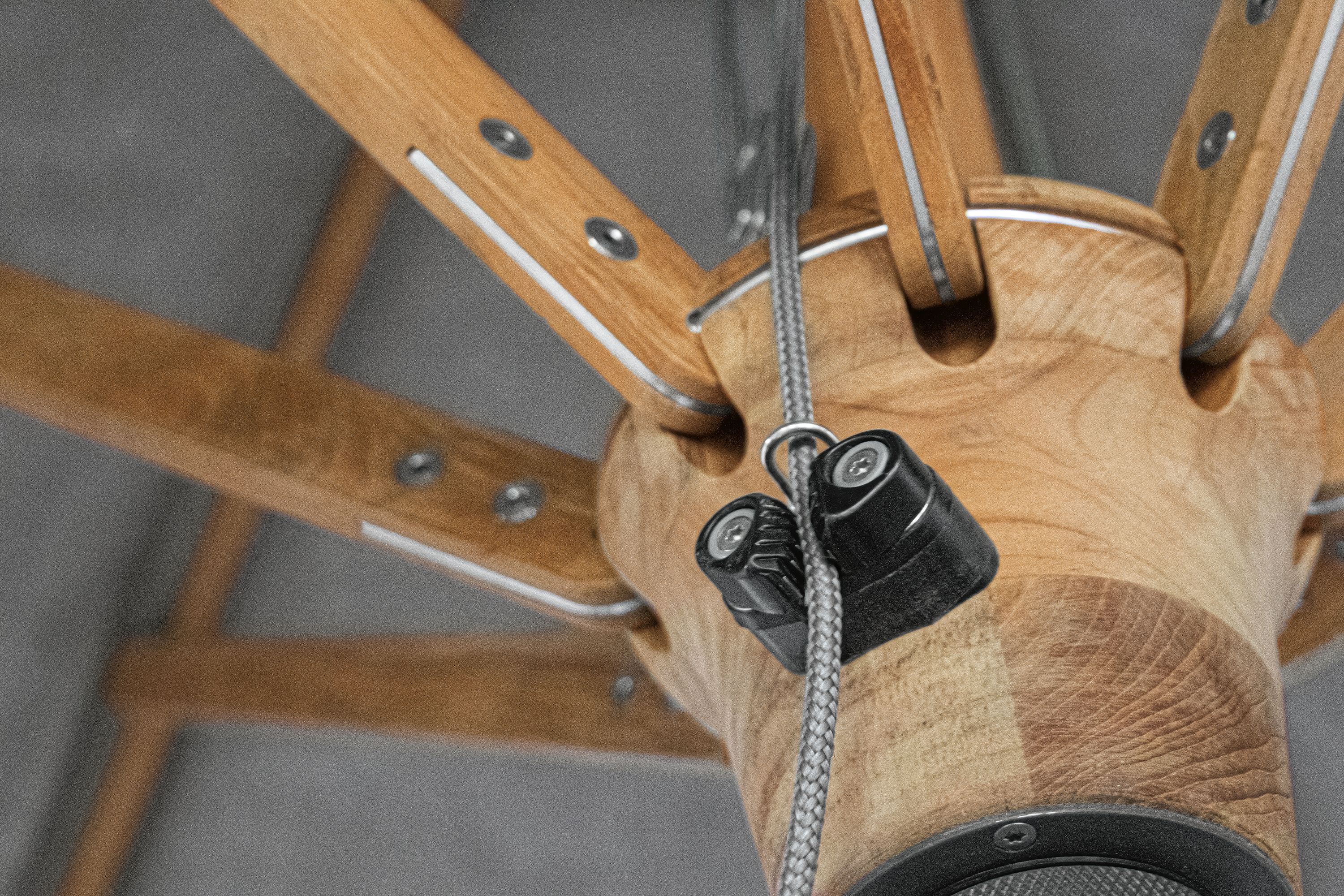 Detail of cam lock for cord on a Banda 10-foot round umbrella in Halo Grey and Teak Hardwood.