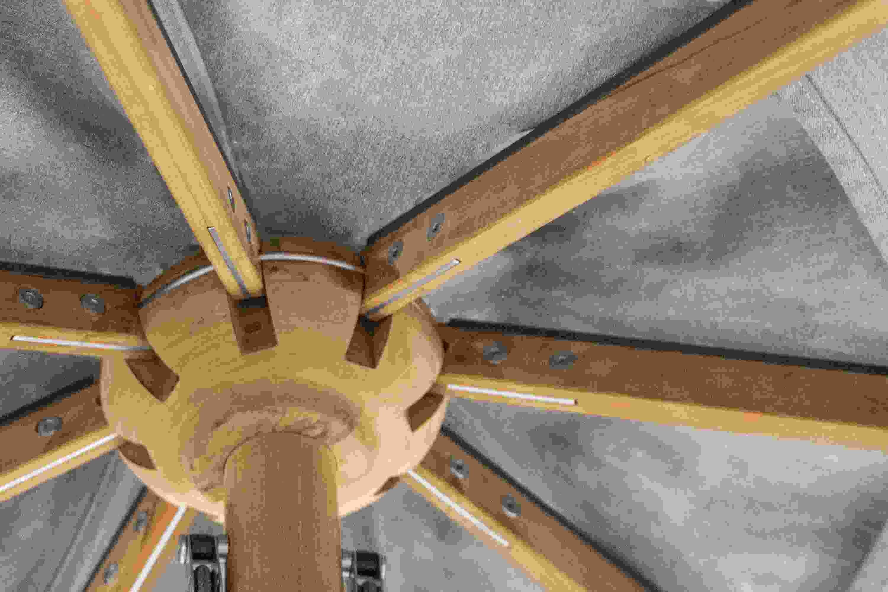Detailed view of the wooden rib assembly on the underside of a Banda 10-foot round patio umbrella in teak.
