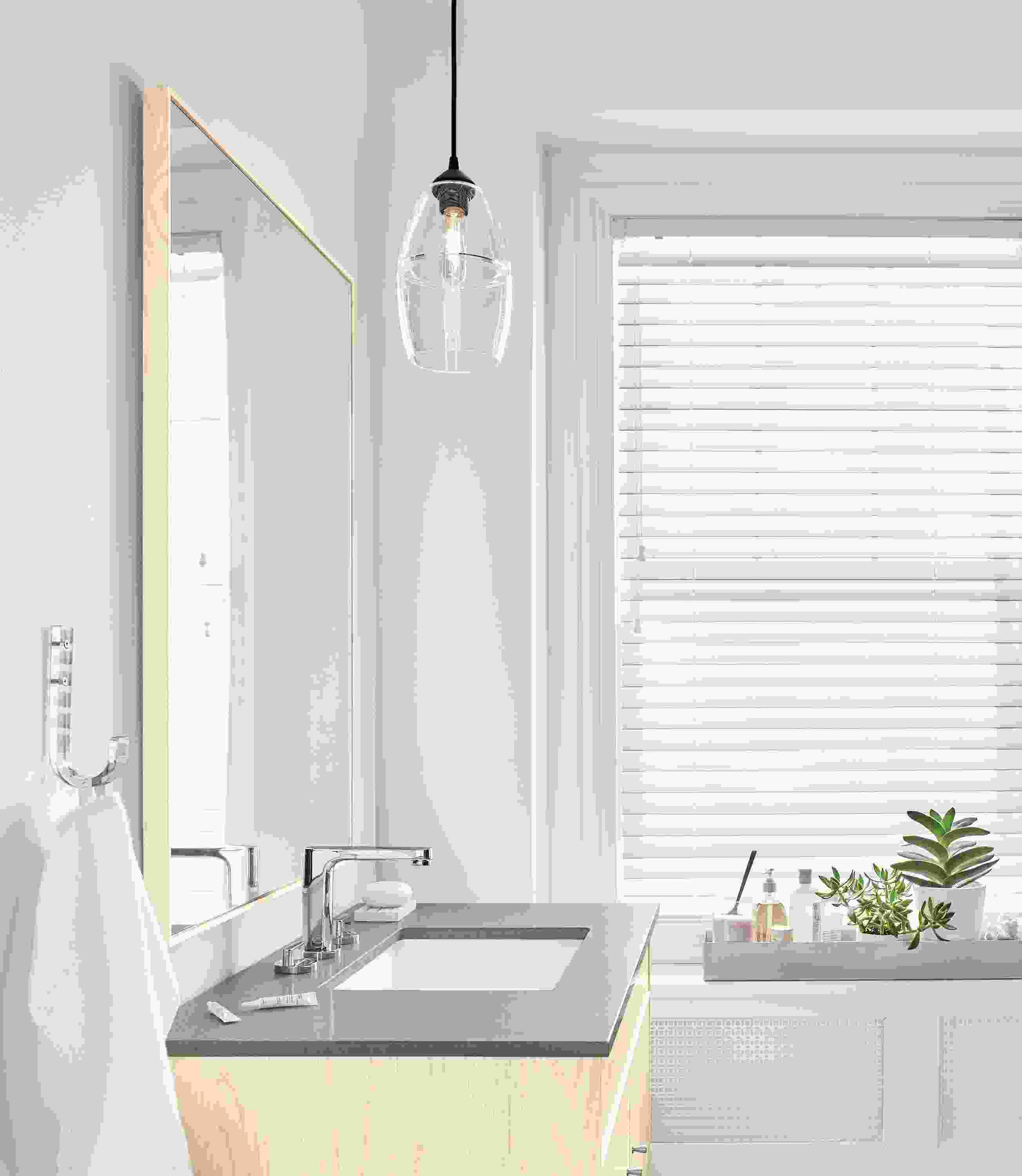 Side detail of Banded cone pendant in bathroom.