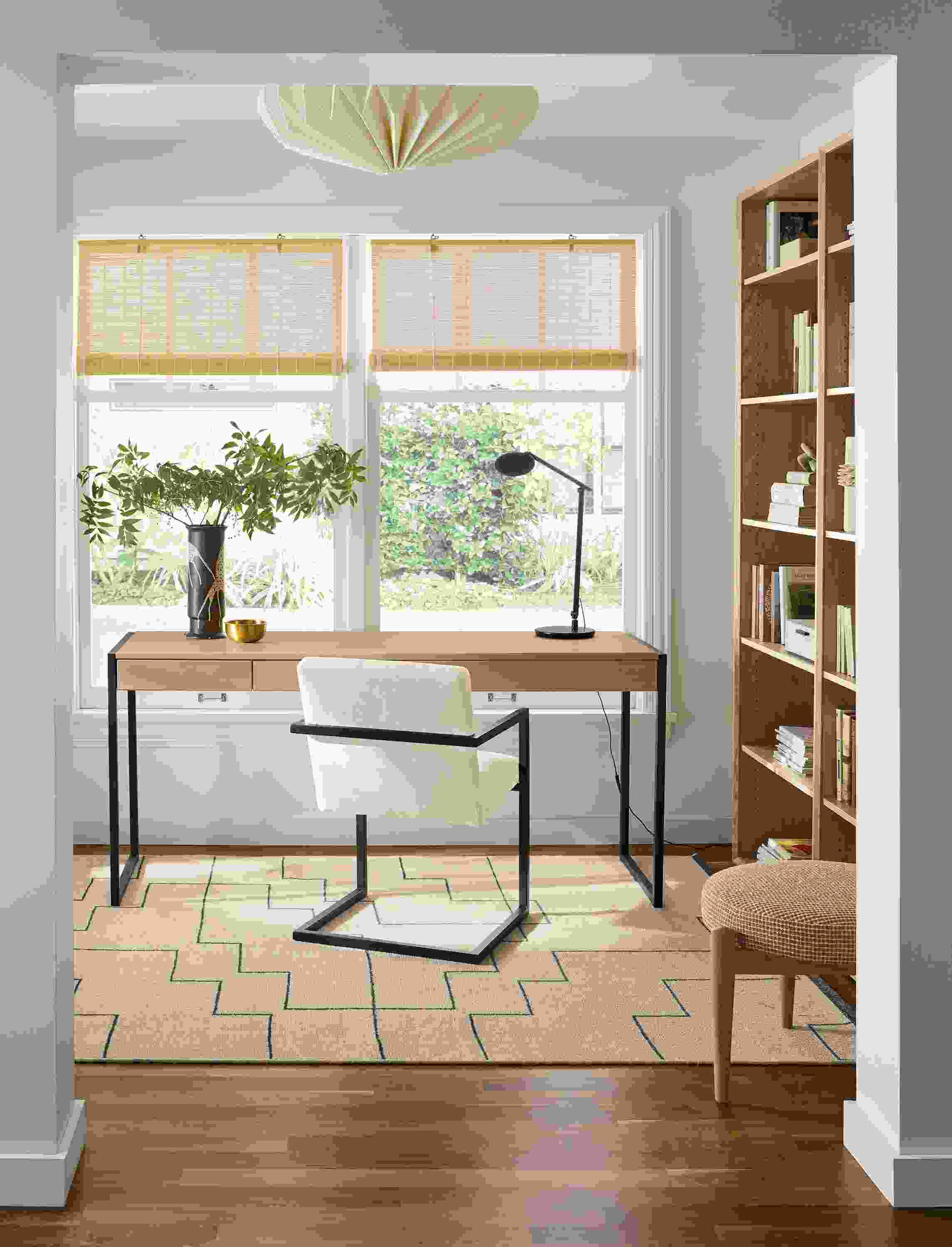 Home office with Basis 66-wide, 2-drawer desk in rye on red oak and Lira arm chair in Sumner Ivory.