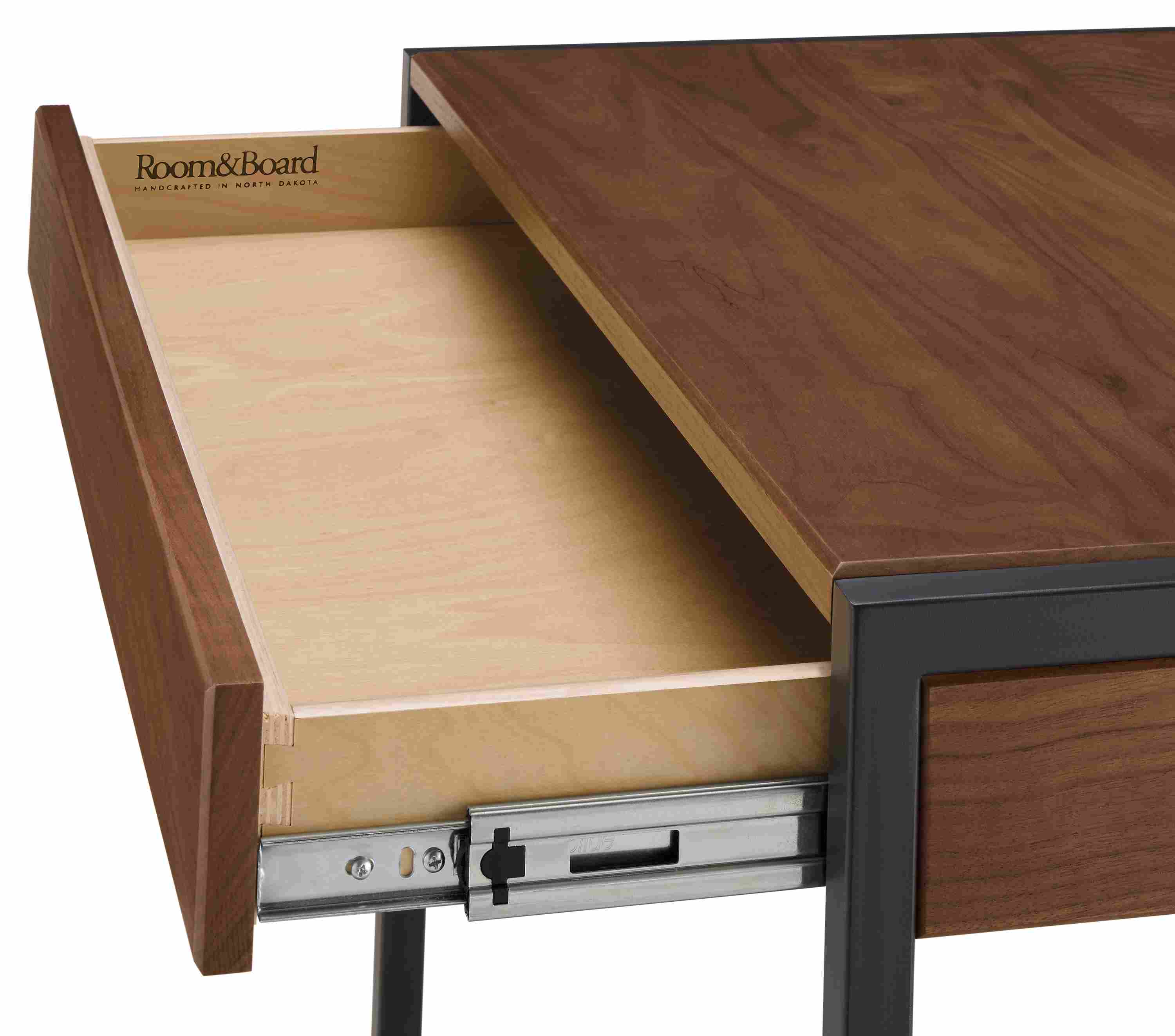 Detail of open drawer and slide mechanism on a basis 36-wide desk in walnut.