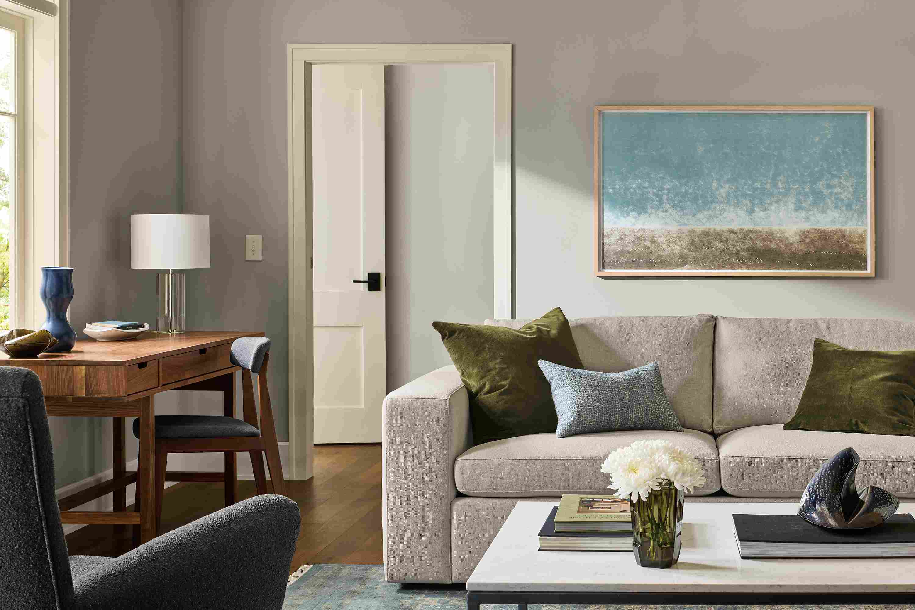 Living room with baylor 88-wide sofa in landen asphalt, boden chair in declan graphite and sivas rug in ocean.
