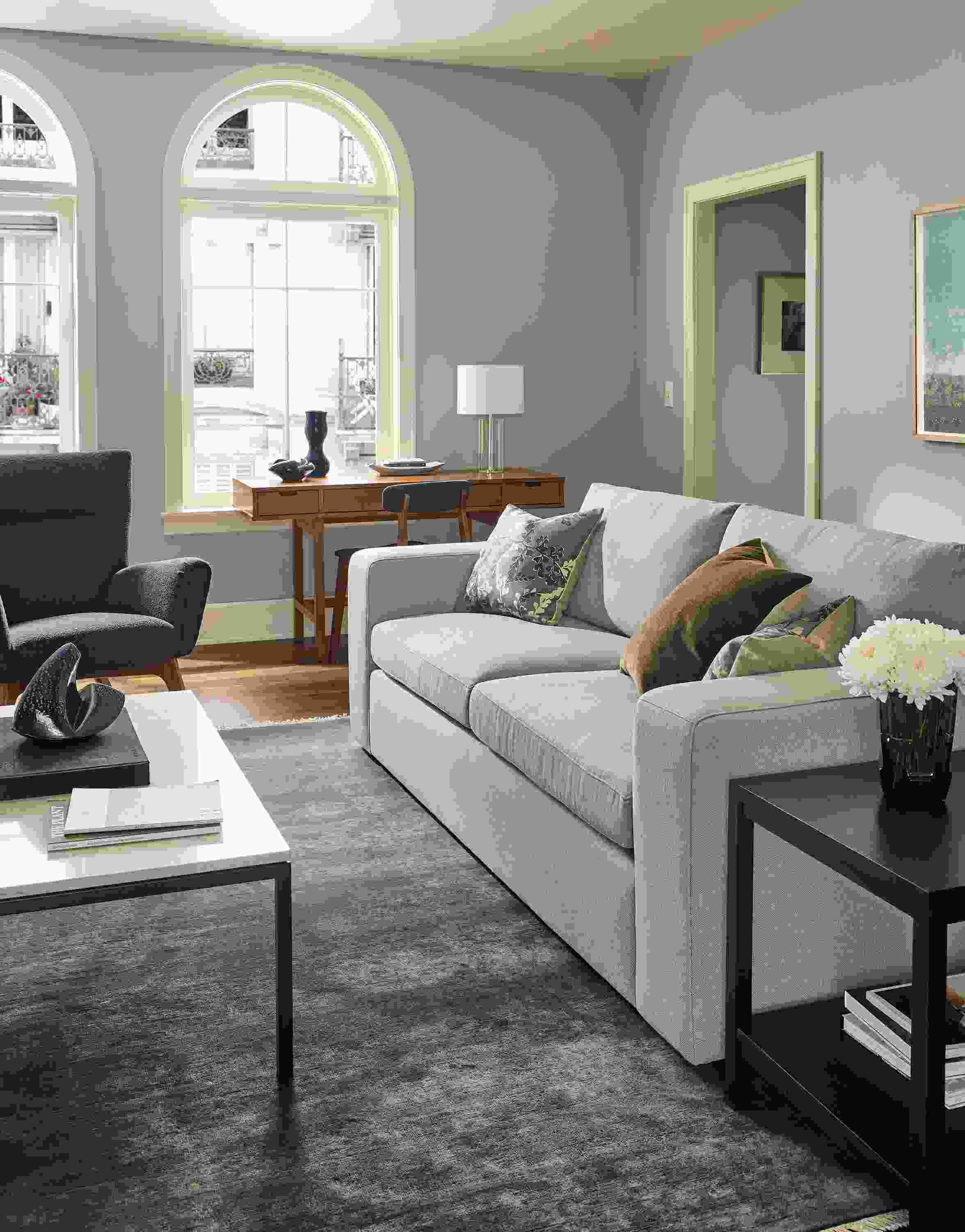 Living room with baylor sofa in landen asphalt, boden chair in declan graphite and sivas rug in ocean.