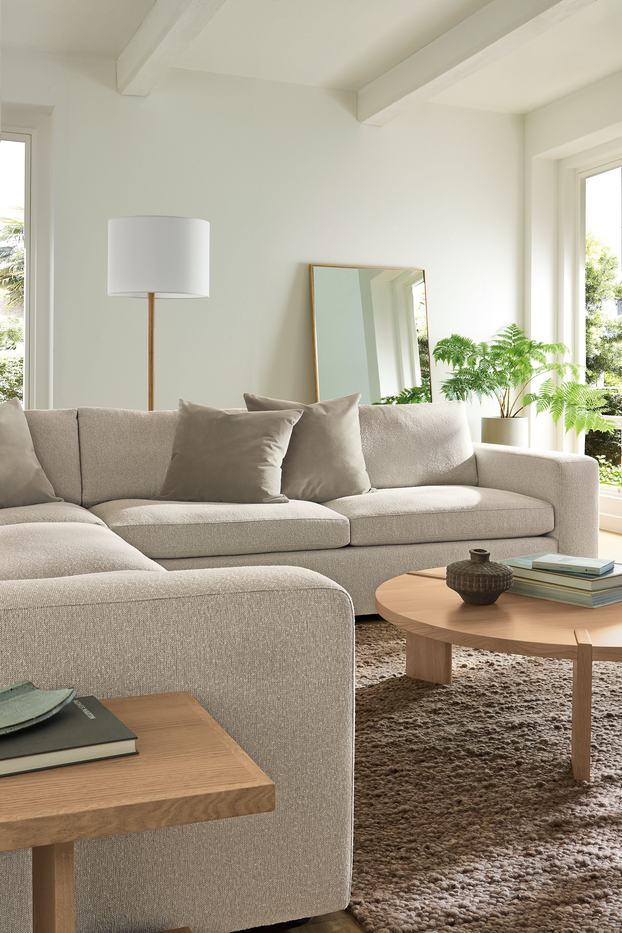 Living room with baylor 3-piece sectional in conley natural, graham end table and hanover coffee table in rye on red oak.
