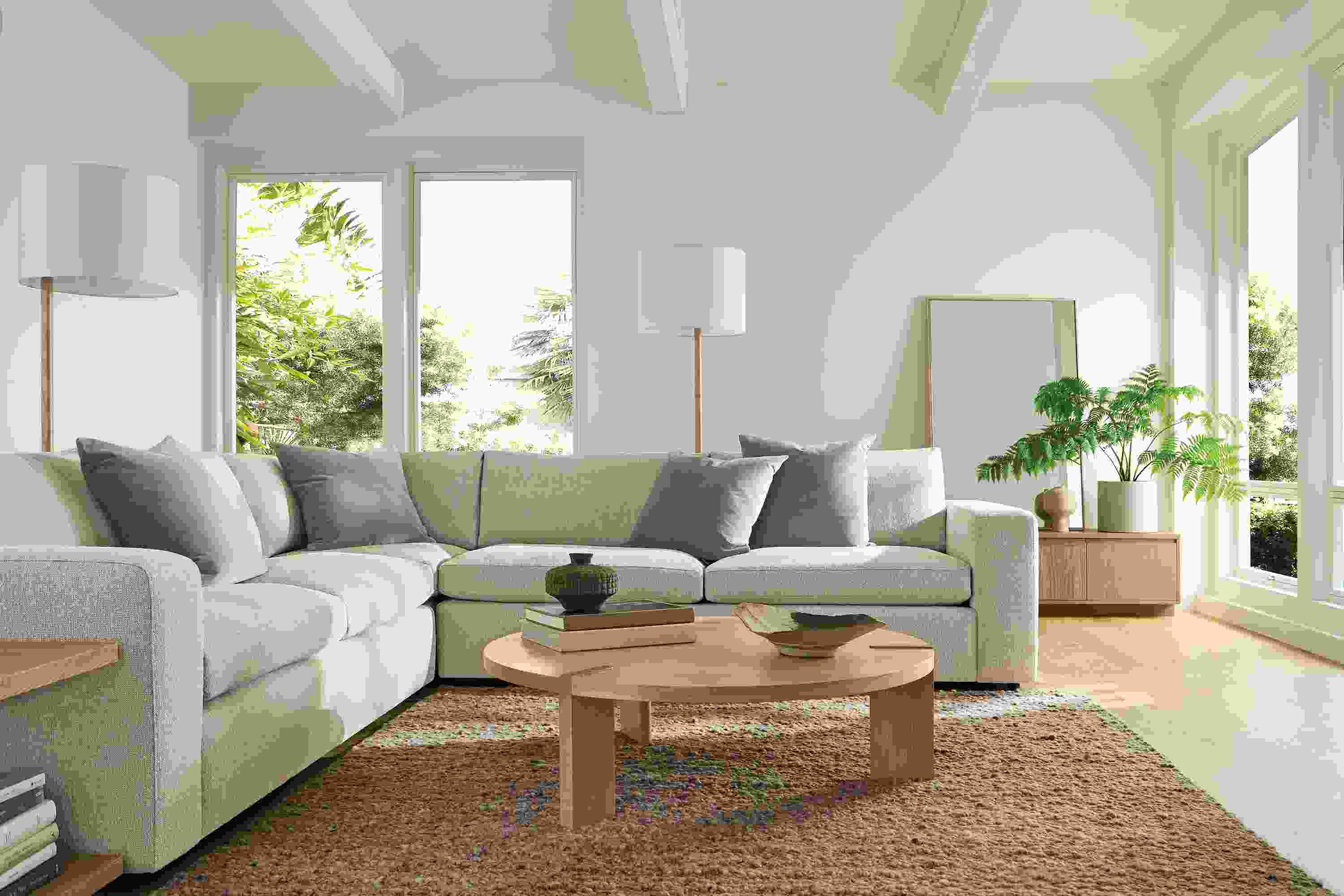 Living room with baylor 3-piece sofa in conley natural, hanover coffee table and graham end table in rye on red oak.
