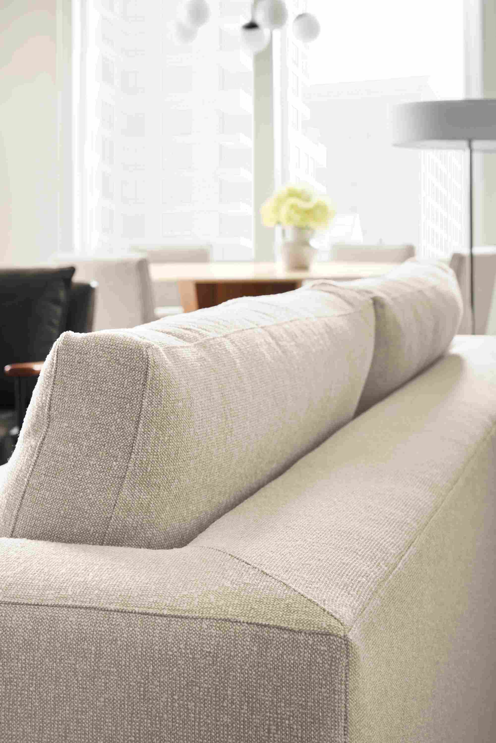 Living room with detail of backside of cushions on a baylor sofa in conley natural fabric.