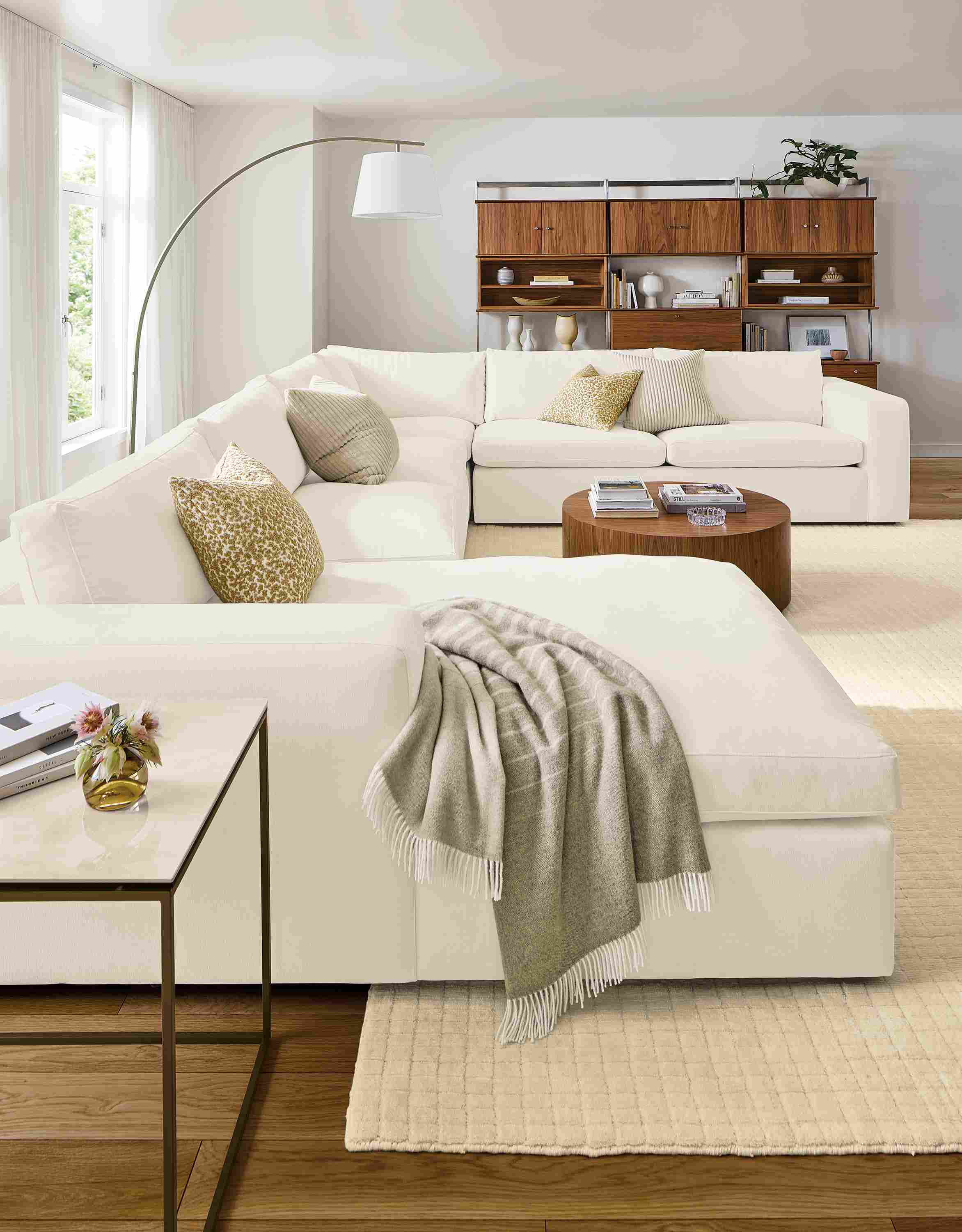 Living room with baylor sectional sofa in mori ivory, tyne end table in walnut and fairfax blanket in natural.