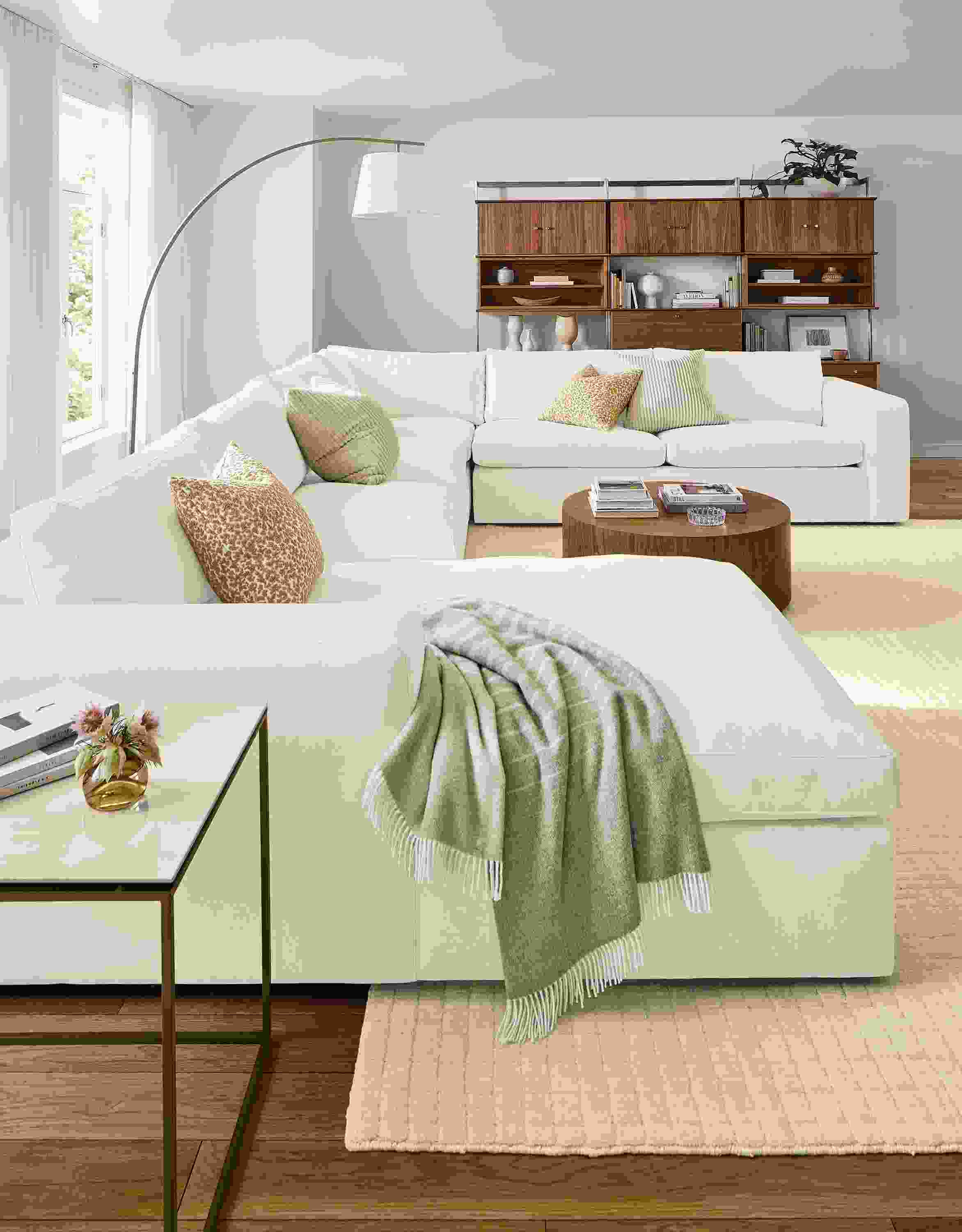 Living room with baylor sectional sofa in mori ivory, tyne end table in walnut and fairfax blanket in natural.