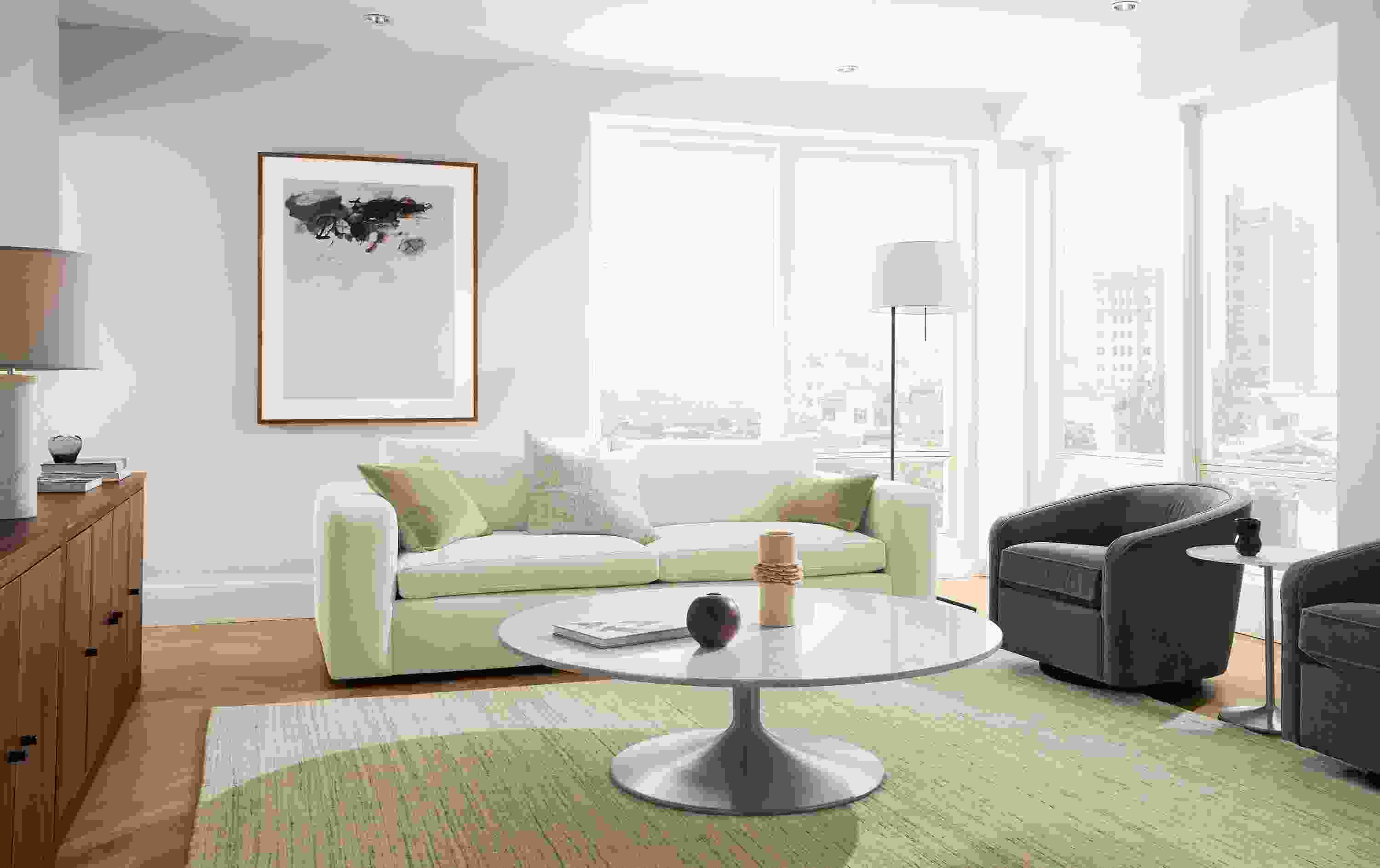 Living room with baylor 98-wide sofa in mori ivory, 2 amos swivel chairs in banks charcoal and nomad 8 by 10 rug in ivory/grey.