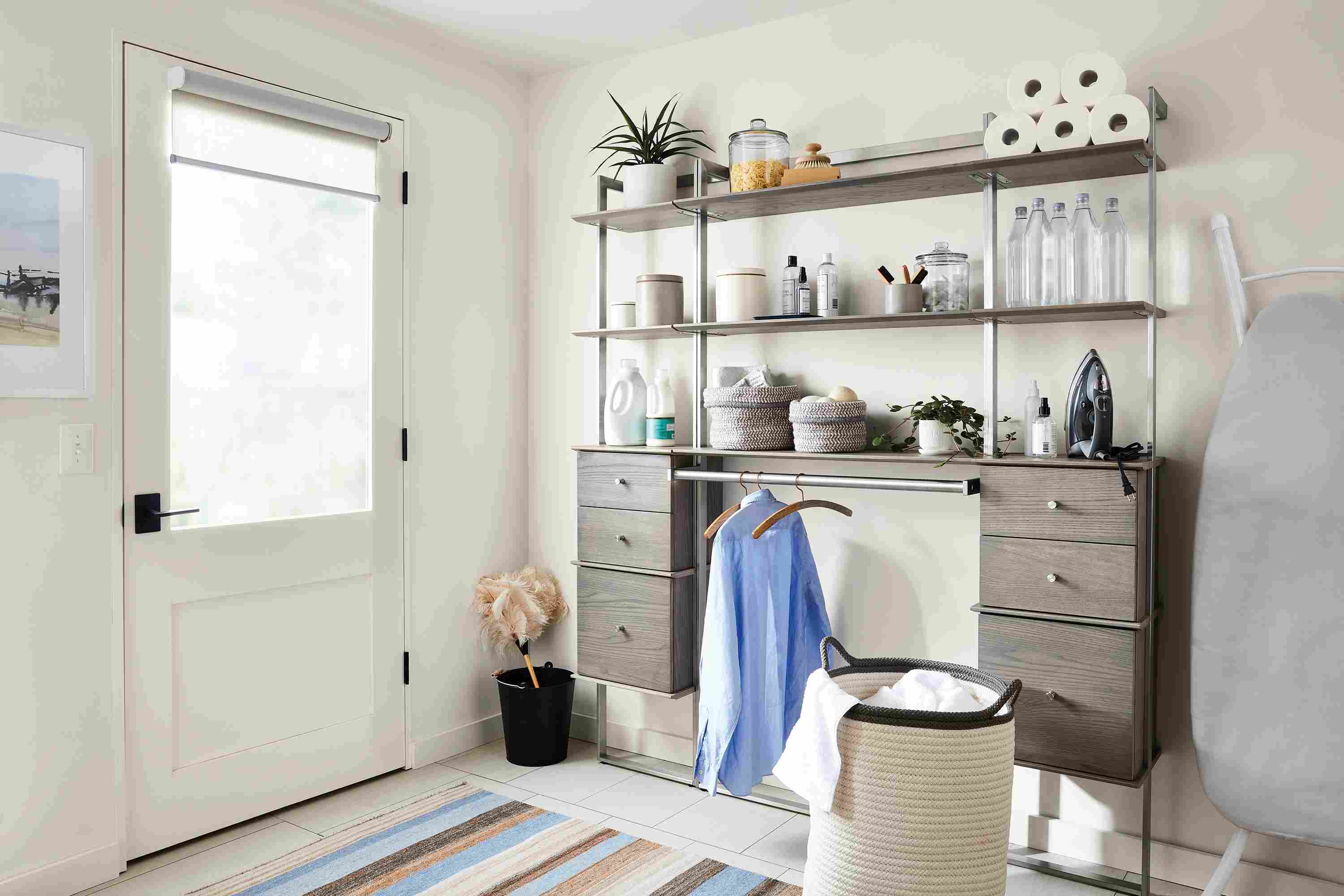 Mudroom laundry area with Beam wall unit in shell and stainless steel with hanging bar and drawer inserts.