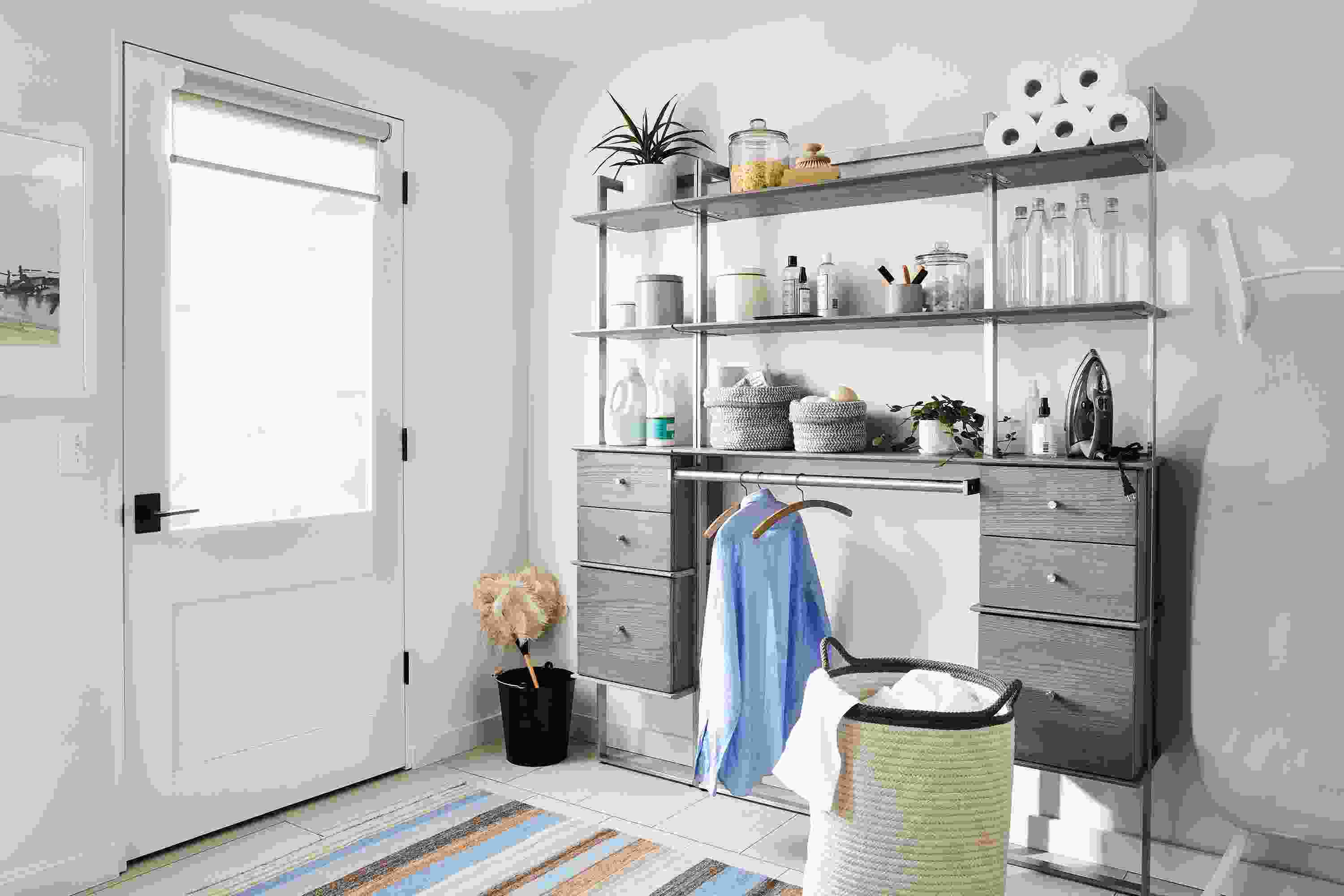 Mudroom laundry area with Beam wall unit in shell and stainless steel with hanging bar and drawer inserts.