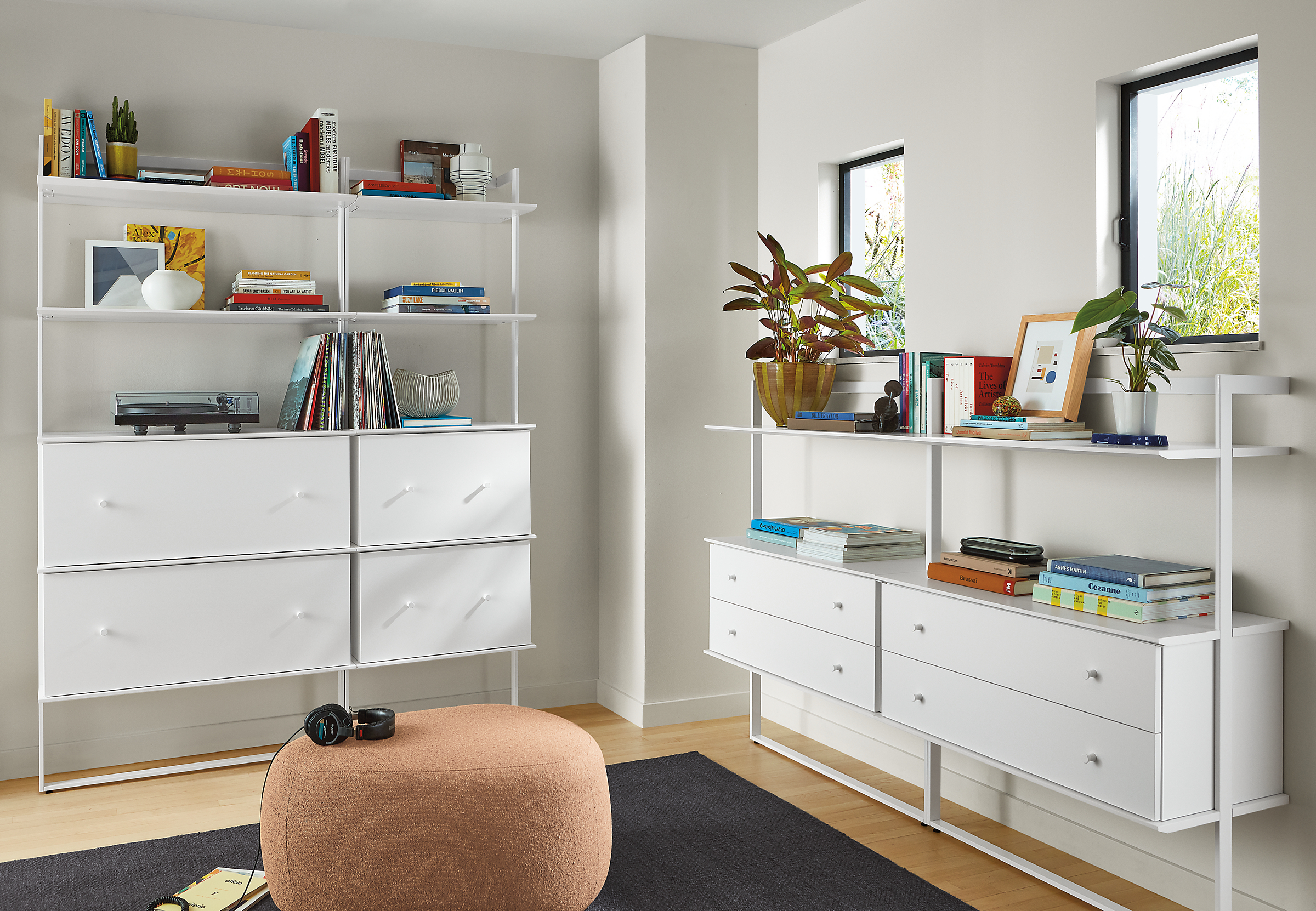 room with beam bookcases in white with white shelving and inserts and asher otttoman in declan sienna fabric.