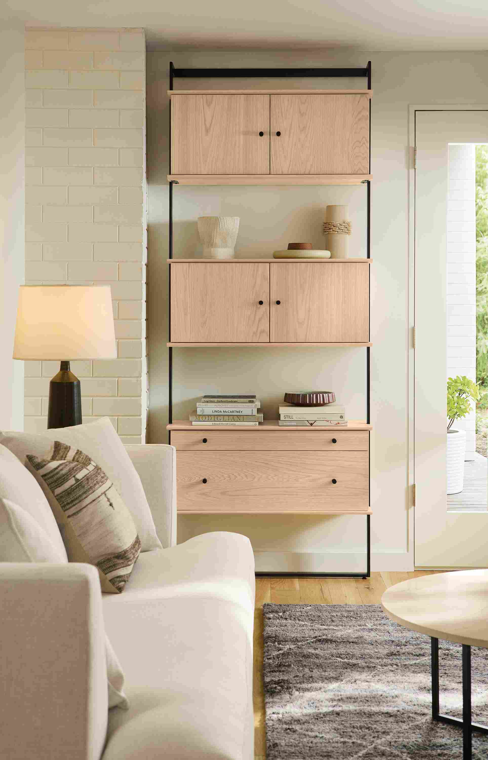Living room with Beam 6-wide bookcase in graphite with beam multiple Beam inserts in salt on red oak.