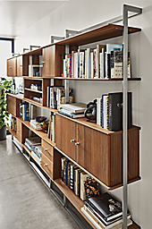 Detail of Beam 140-wide Bookcase Wall Unit with Inserts in stainless steel and walnut.