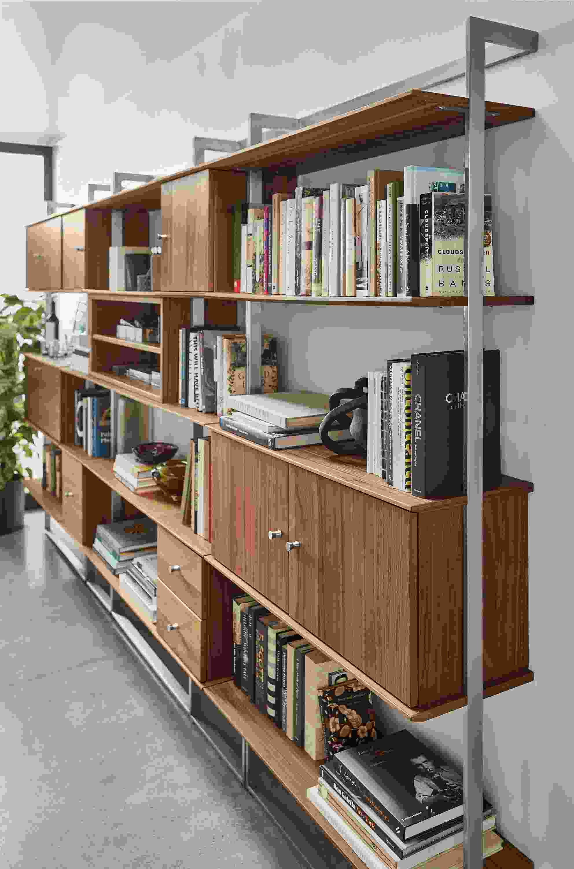 Detail of Beam 140-wide Bookcase Wall Unit with Inserts in stainless steel and walnut.