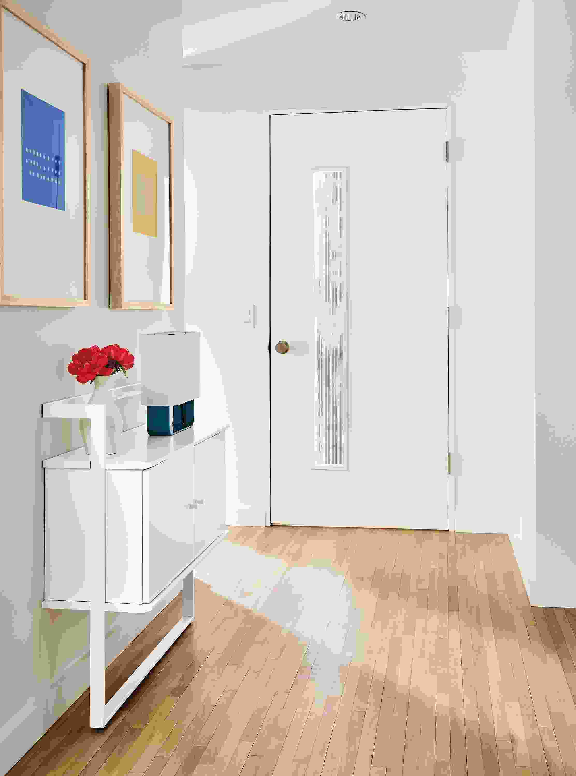 Entryway with small Beam bookcase in white, Juni van dyke wall art, duo lamp.