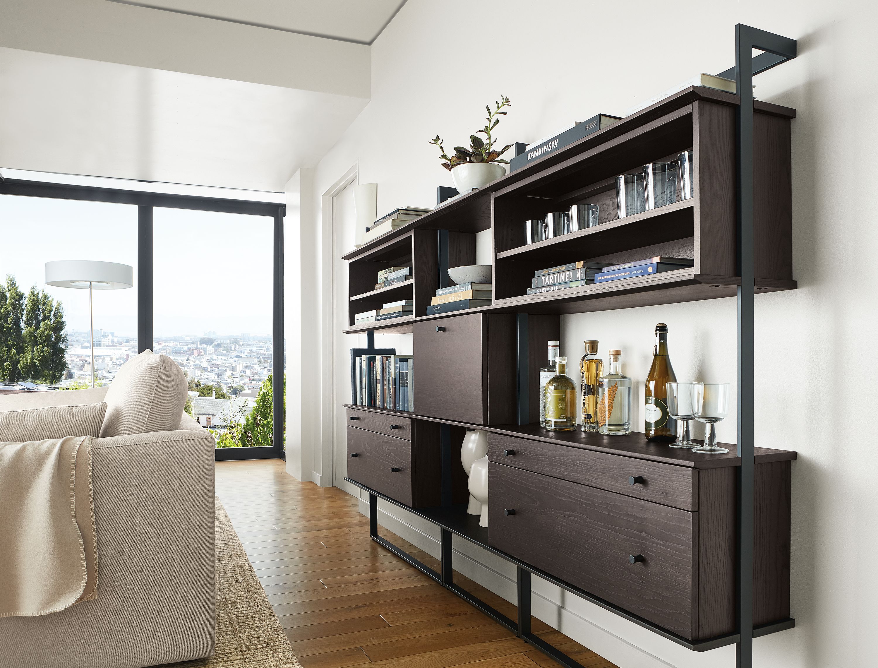 Two 36w 12d 63h bookcases with adjustable shelf and small drawer/large drawer inserts, 24w 12d 63h four shelves bookcase (center) with drop-down surface in charcoal stain/graphite