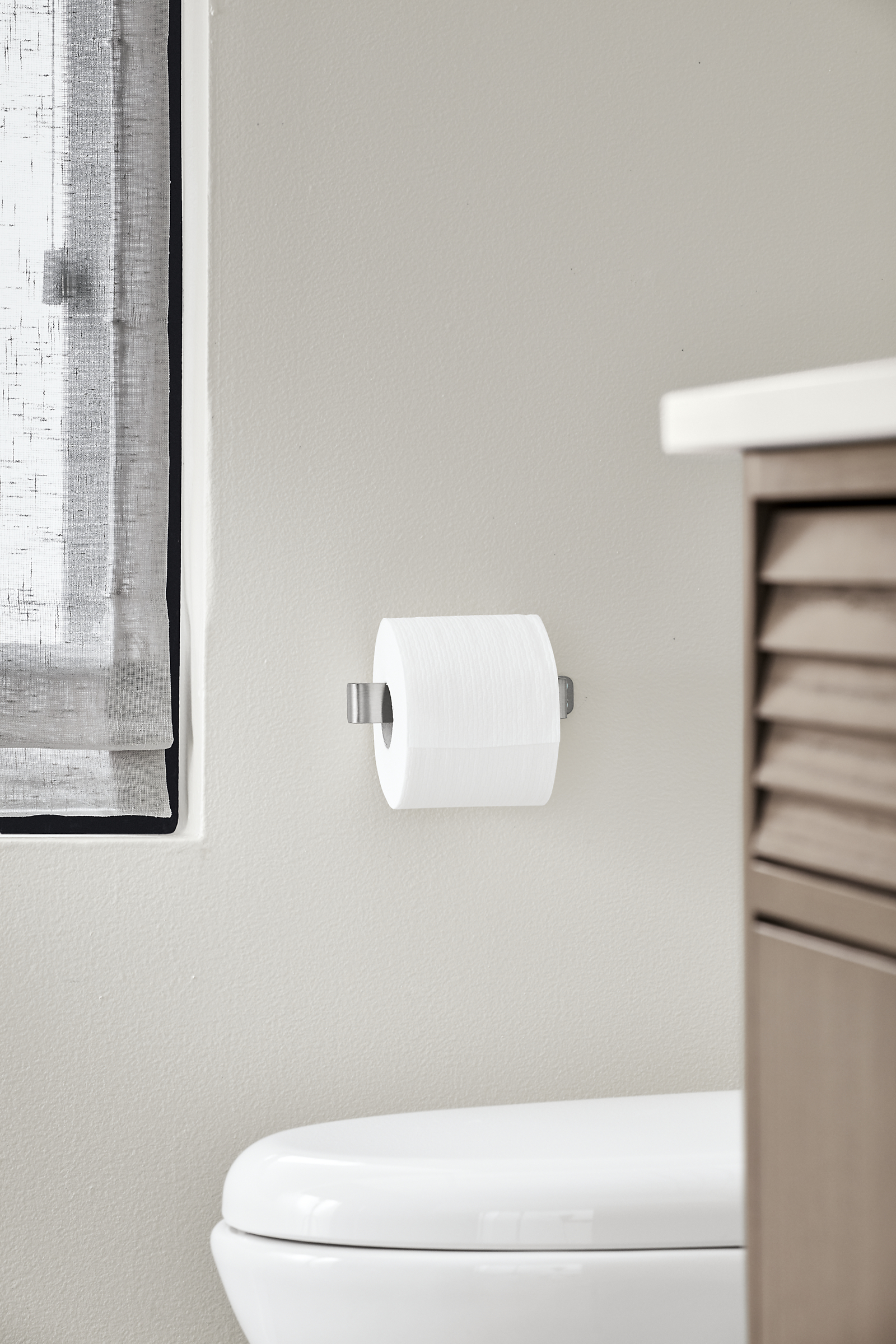 Detail of Bend wall mounted single toilet paper holder.