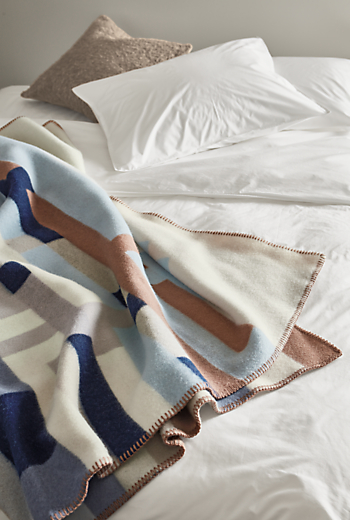 detail of Bergstaden Throw Blanket in Beige/Blue on bed.