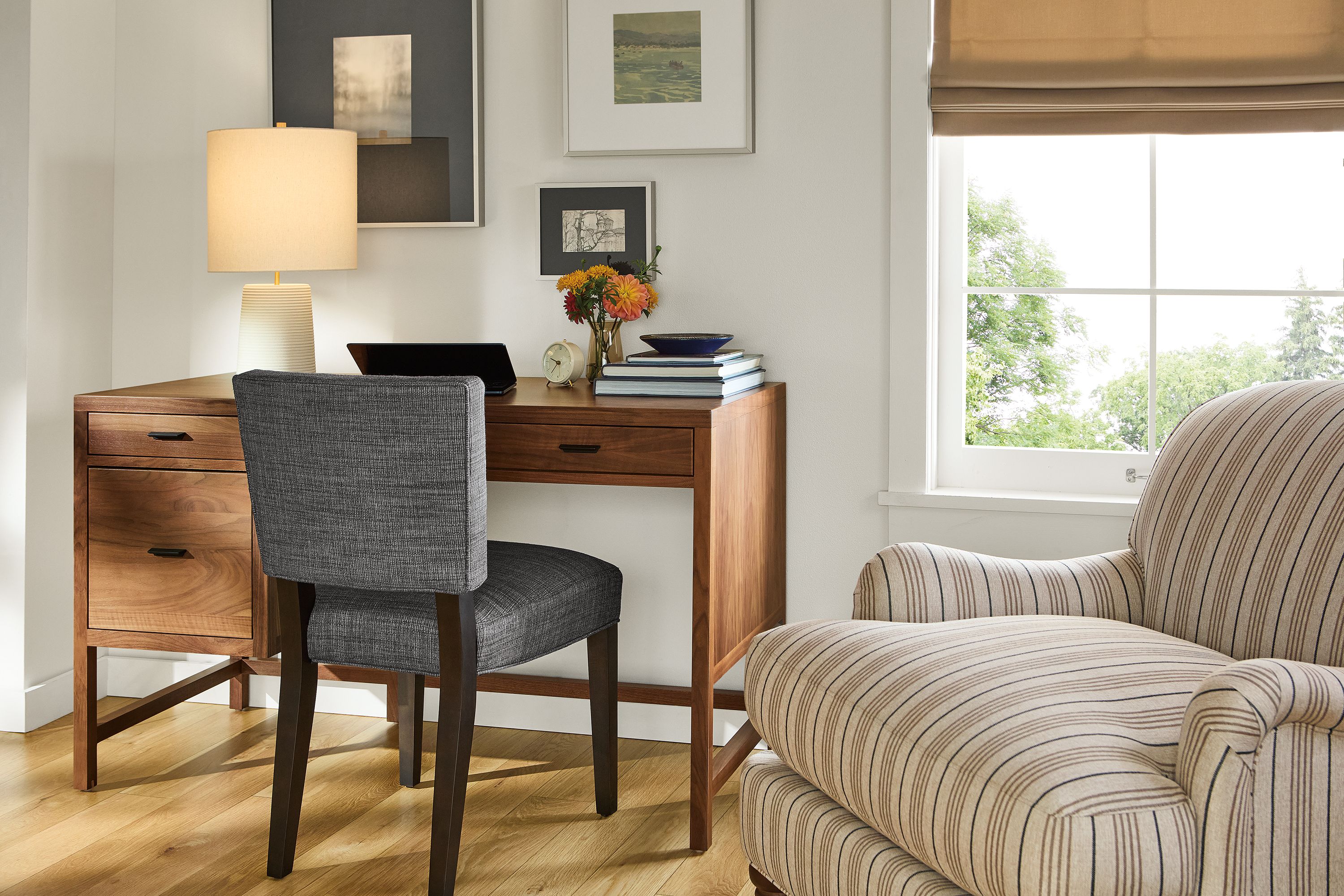Living room with Berkeley 50-wide desk with file drawer in walnut and Georgia side chair in Alston Ink with charcoal legs.