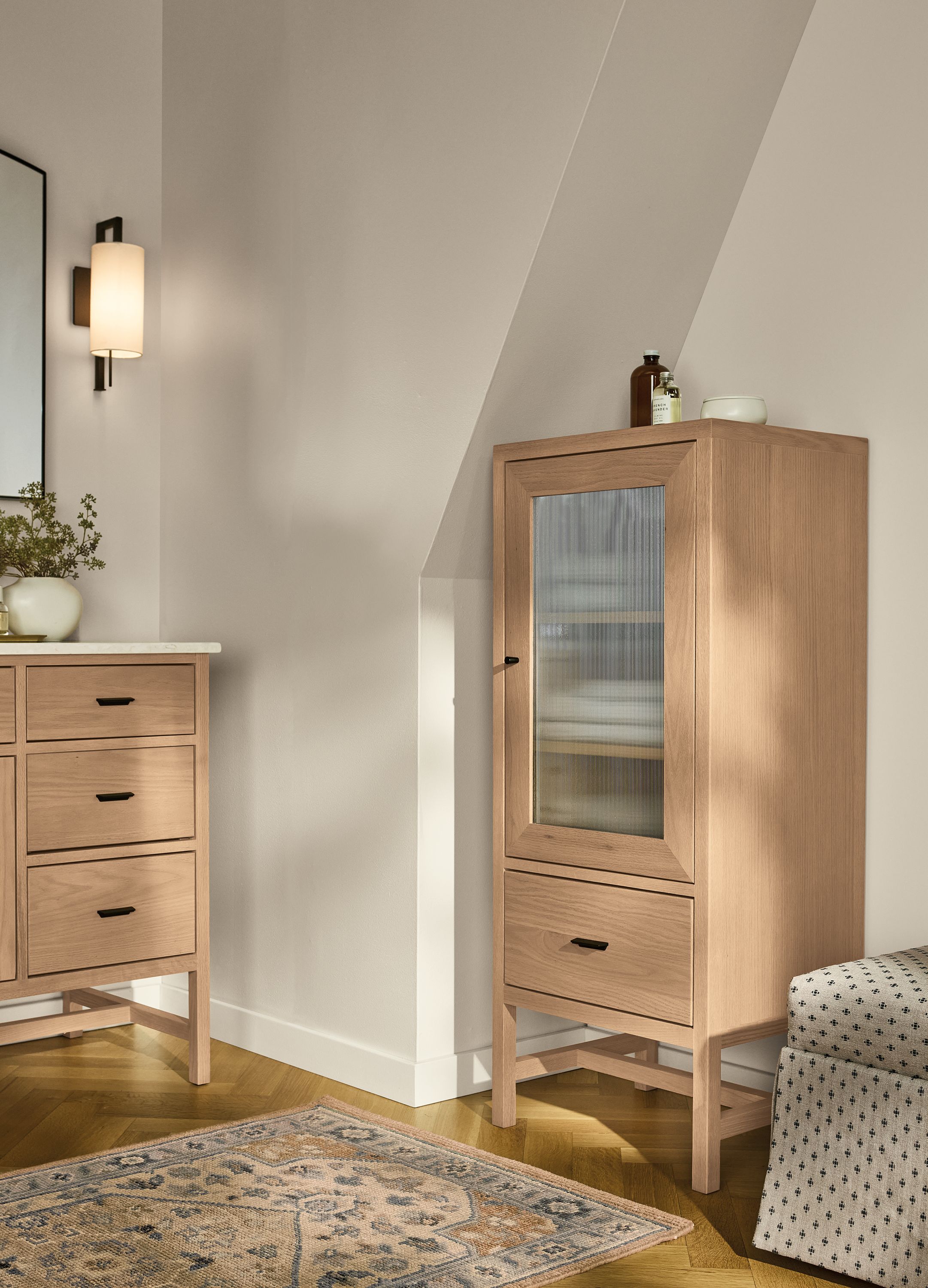 Bathroom with Berkeley Linen Cabinet with glass door and Berkeley single-sink vanity in rye on red oak.