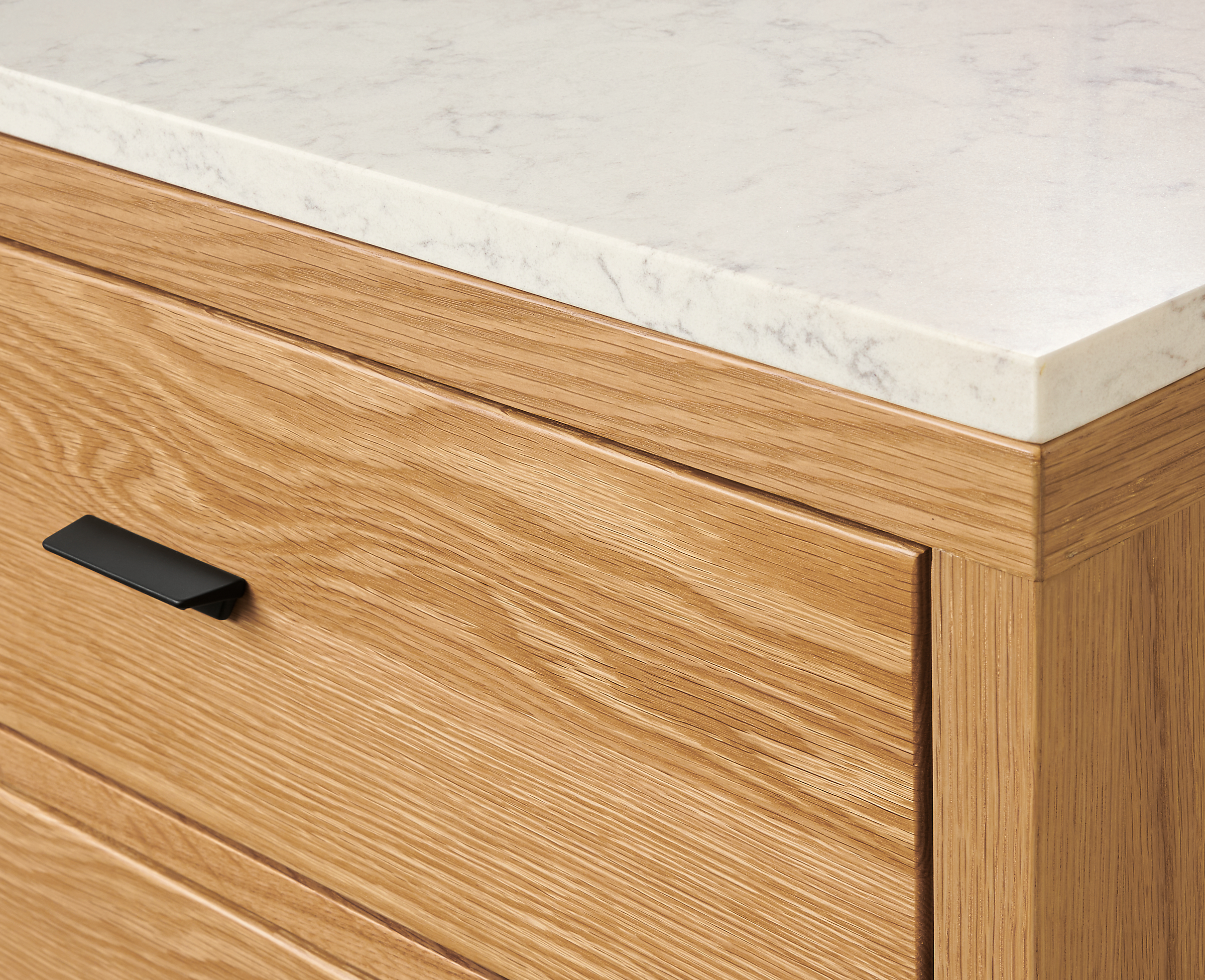 Close up detail of Berkeley storage cabinet in White Oak with Marbled White Quartz Top.