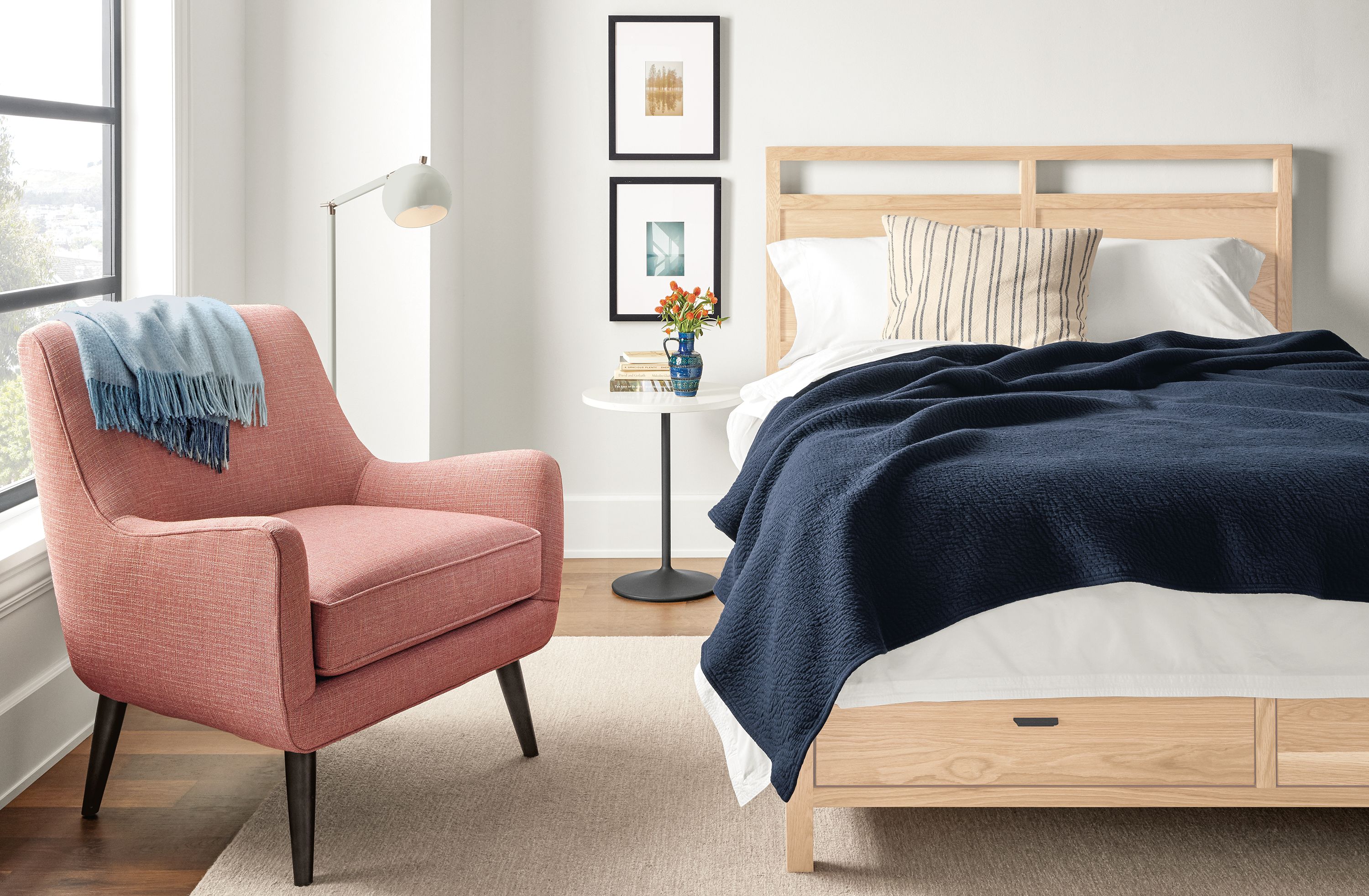 Bedroom with berkeley queen storage bed in salt on red oak, aria end table and alder 8 by 10 rug in ivory.