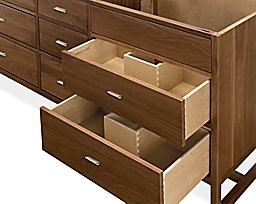 Close-up of Berkeley 70.5-wide vanity cabinet in walnut and polished nickel pulls shown with two of the drawers open.