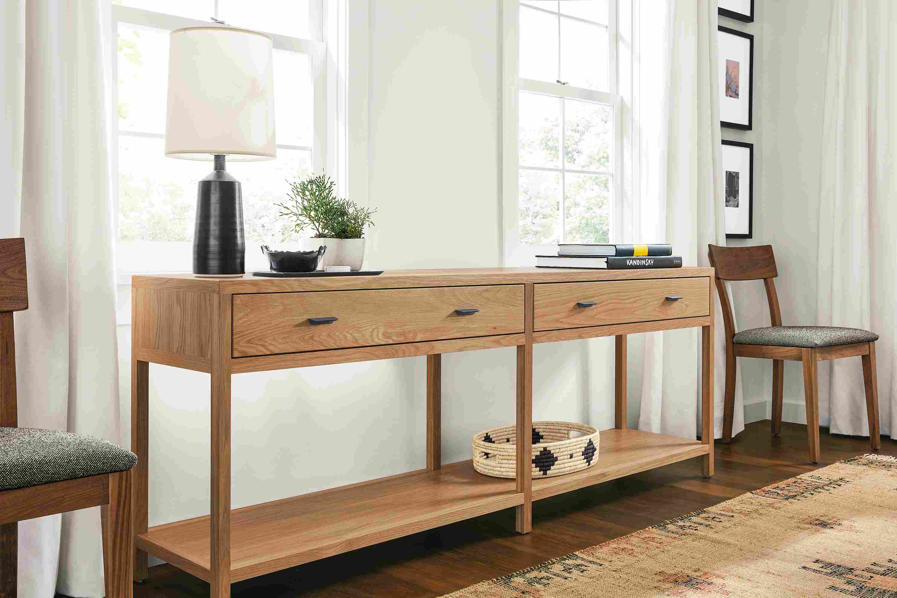Living room with detail of Berkeley 78-wide console table in rye on red and Vira rug in terracotta.