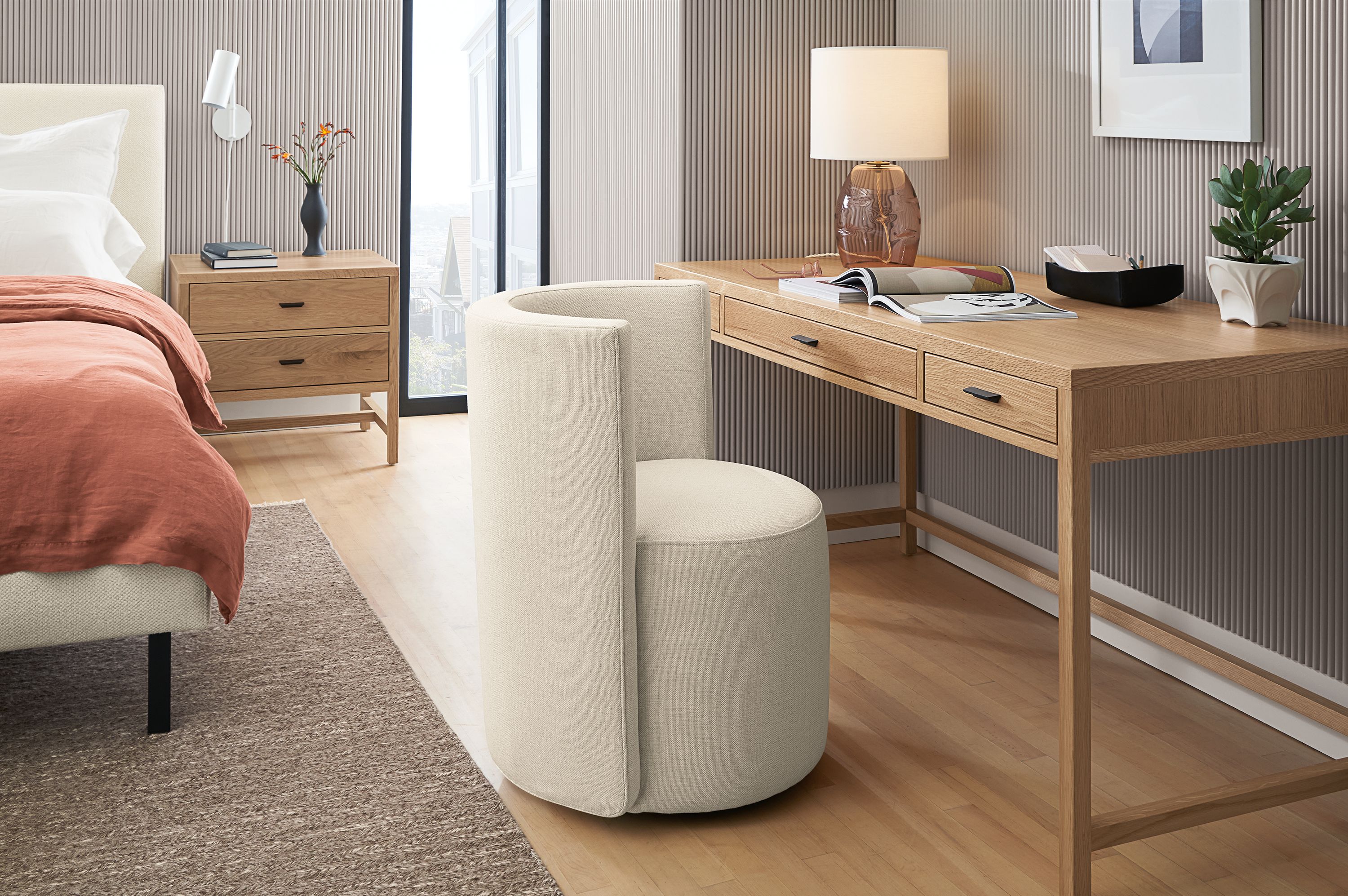 Bedroom with berkeley 60-wide desk in rye on red oak and como dining chair in sumner ivory.